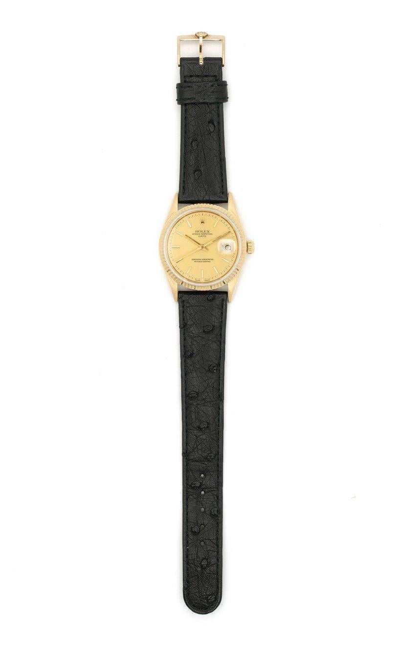 Rolex Oyster Perpetual Date Watch c.1986
Model 15037 
14K Yellow Gold 
Rolex Black Ostrich Leather Strap - pristine condition
Automatic Movement
Original Gold Dial - pristine condition
Made in Switzerland