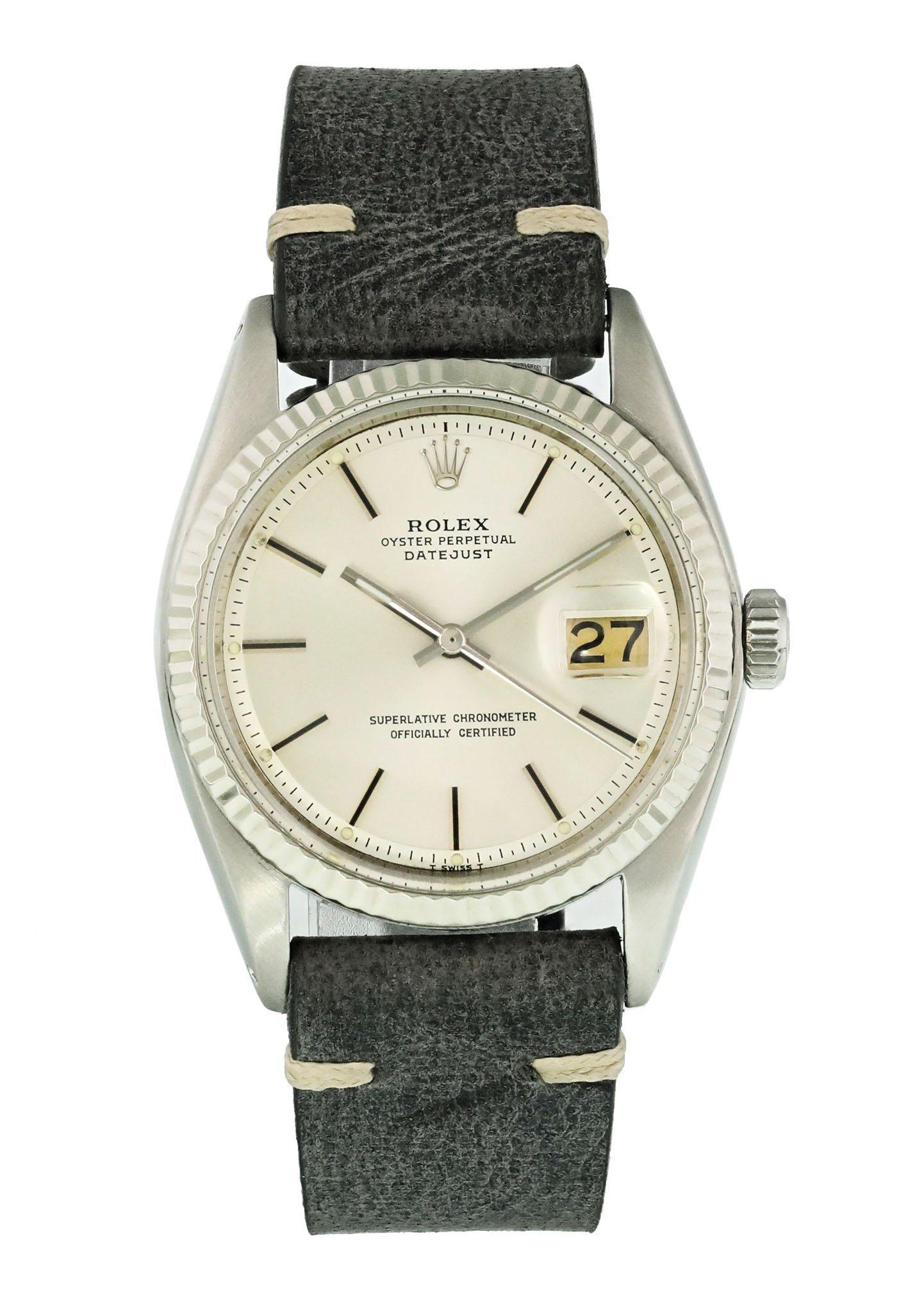 Rolex Oyster Perpetual Datejust 1601 Men's Watch. 
36mm stainless steel case with an 18K white gold fluted bezel. 
Silver dial with steel hands and index hour markers. 
Minute markers around the outer dial. 
Date display at the 3 o'clock position.