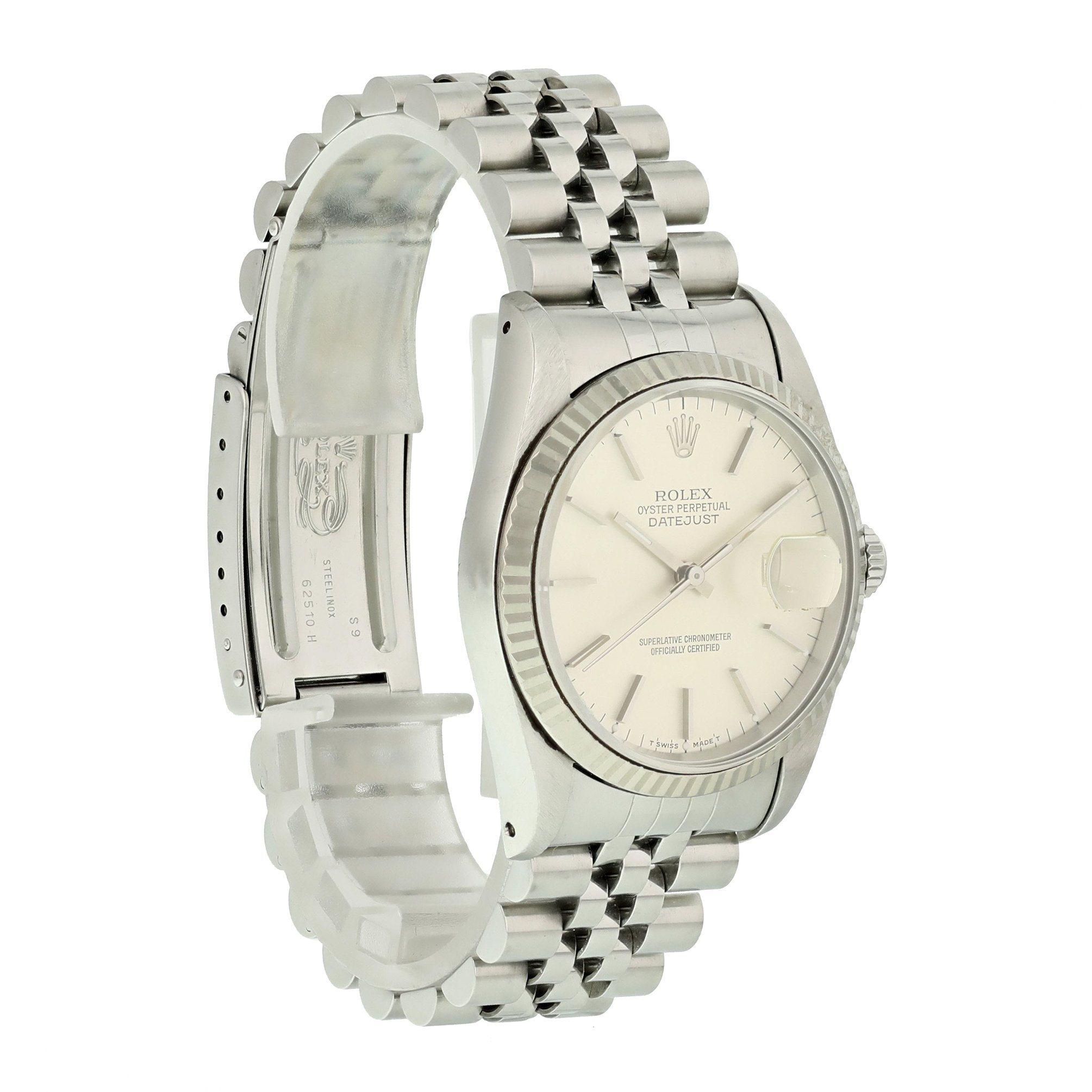 Rolex Oyster Perpetual Datejust 16234 Mens Watch. 
36mm Stainless Steel case. 
White Gold Stationary bezel. 
Silver dial with Luminous Steel hands and index hour markers. 
Minute markers on the outer dial. 
Date display at the 3 o'clock position.