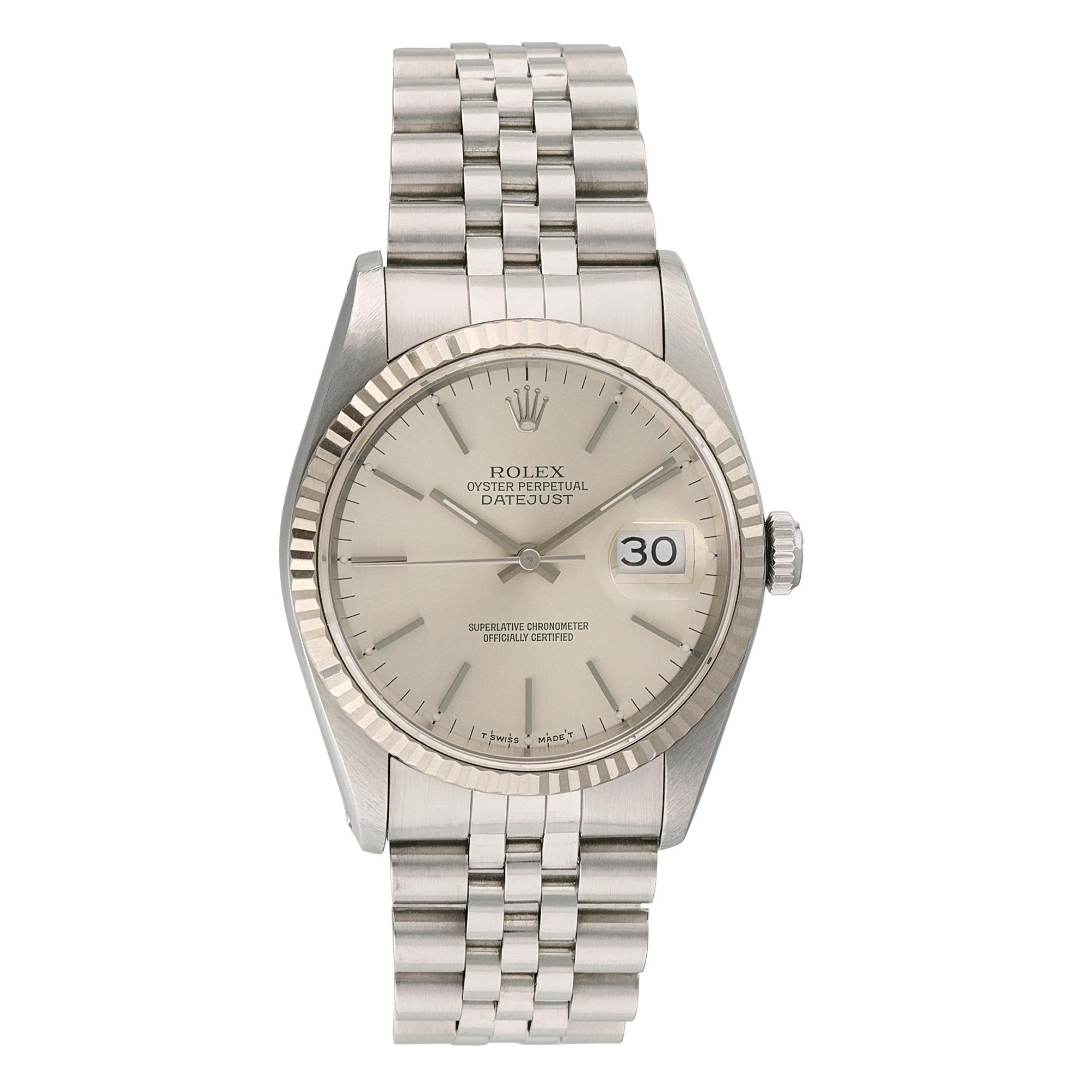 Rolex Oyster Perpetual Datejust 16234 Mens Watch. 
36mm Stainless Steel case. 
White Gold fluted bezel. 
Silver dial with Luminous Steel hands and index hour markers. 
Minute markers on the outer dial. 
Date display at the 3 o'clock position.