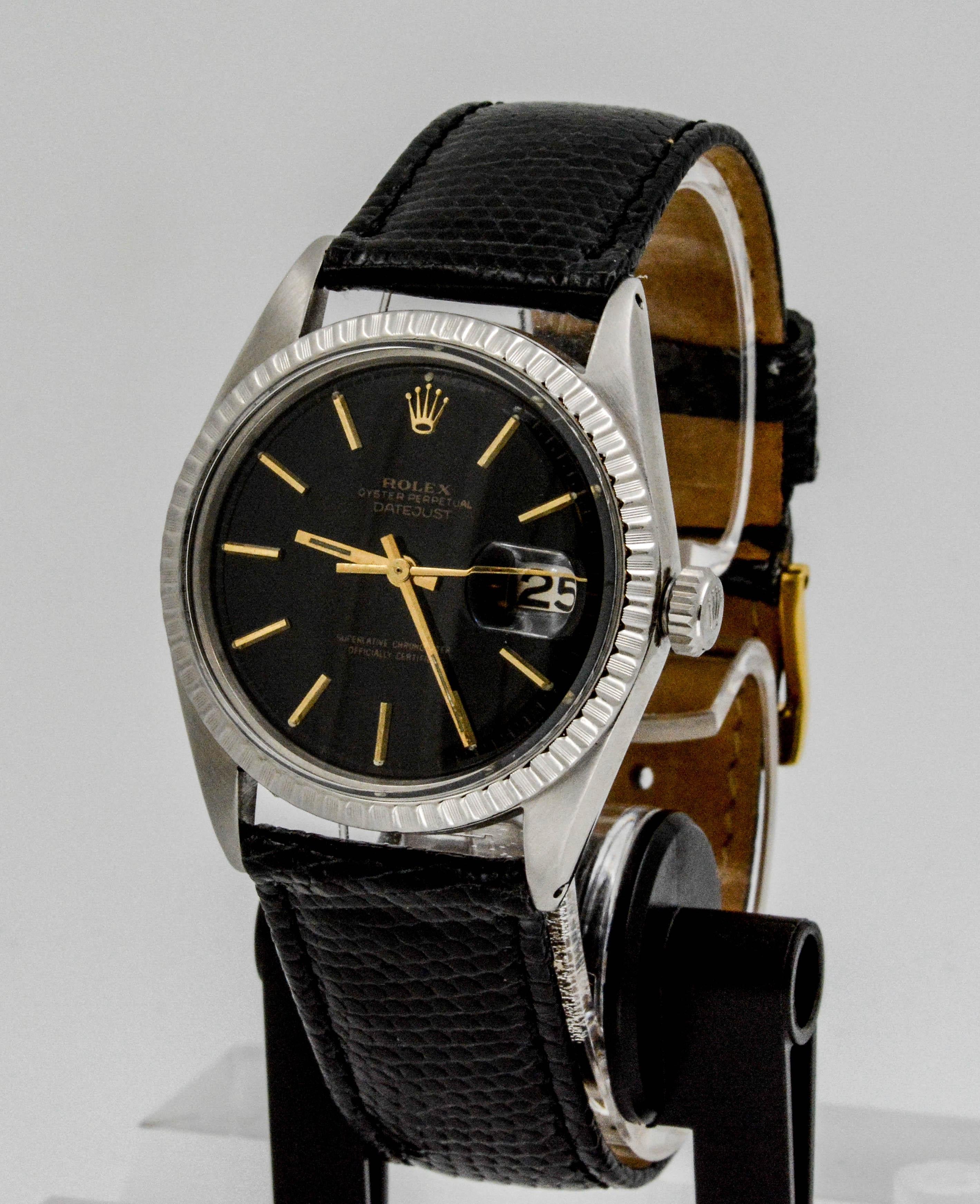 • Model: Rolex DATEJUST 
• Movement: Perpetual, automatic 
• Case Size: 36mm 
• Case Material: Stainless steel with fluted bezel, acrylic crystal 
• Dial: Black dial with gold stick markers
• Strap: Black lizard leather (not an authentic Rolex