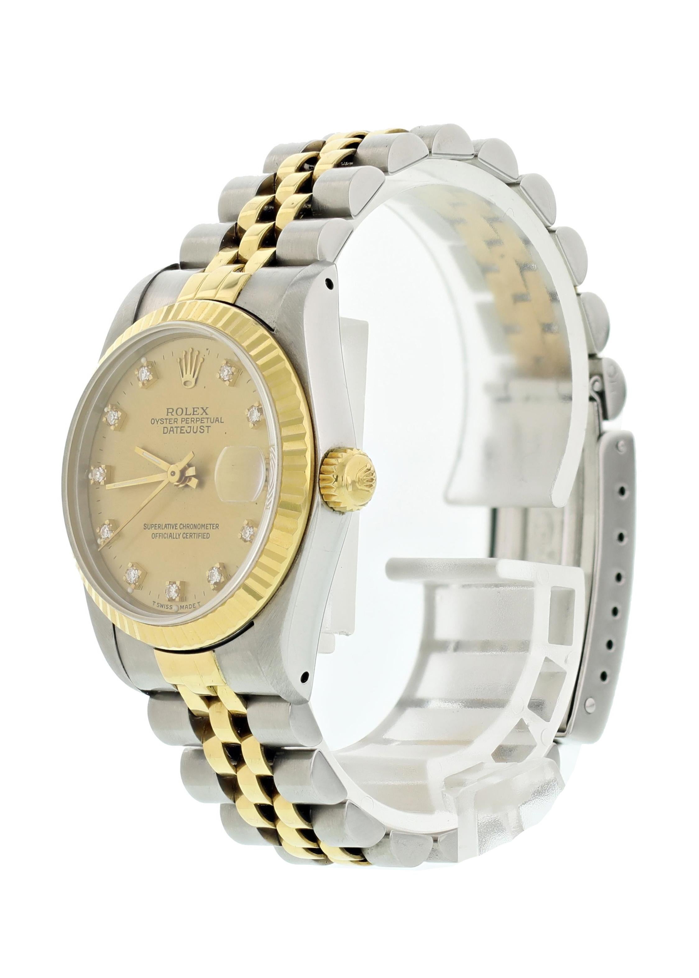 Rolex Oyster Perpetual Datejust 68273 Midsize Ladies Watch. 31mm stainless steel case. 18K yellow gold Fluted bezel. Champagne dial with Gold hands and factory placed Diamond Hour Markers. Minute markers around the dial. Date display. Two-tone