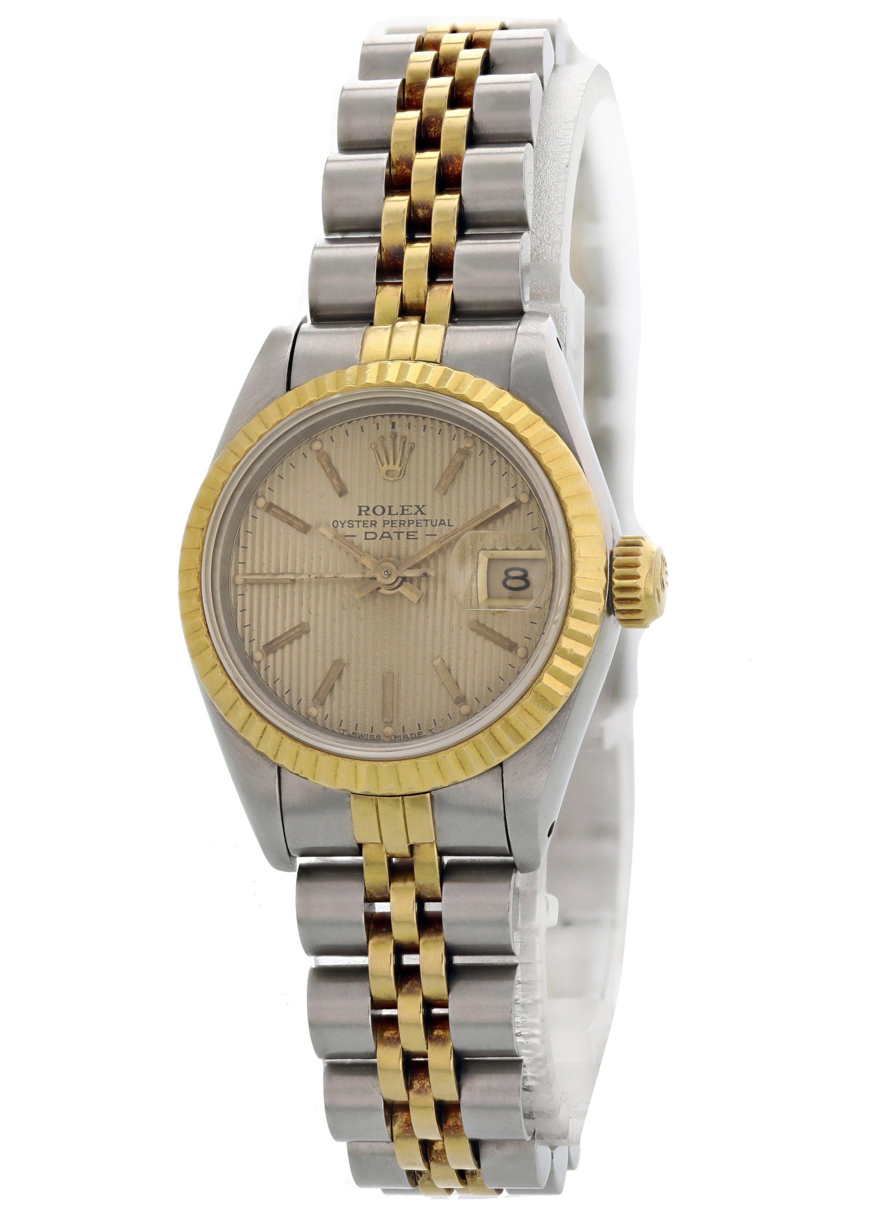 Rolex Oyster Perpetual Datejust Tapestry Dial Ladies Watch. Reference 69173. 26 mm stainless steel case. 18k yellow gold fluted bezel. Champagne tapestry dial with yellow gold hands and stick markers. 18k yellow gold and stainless steel Jubilee band
