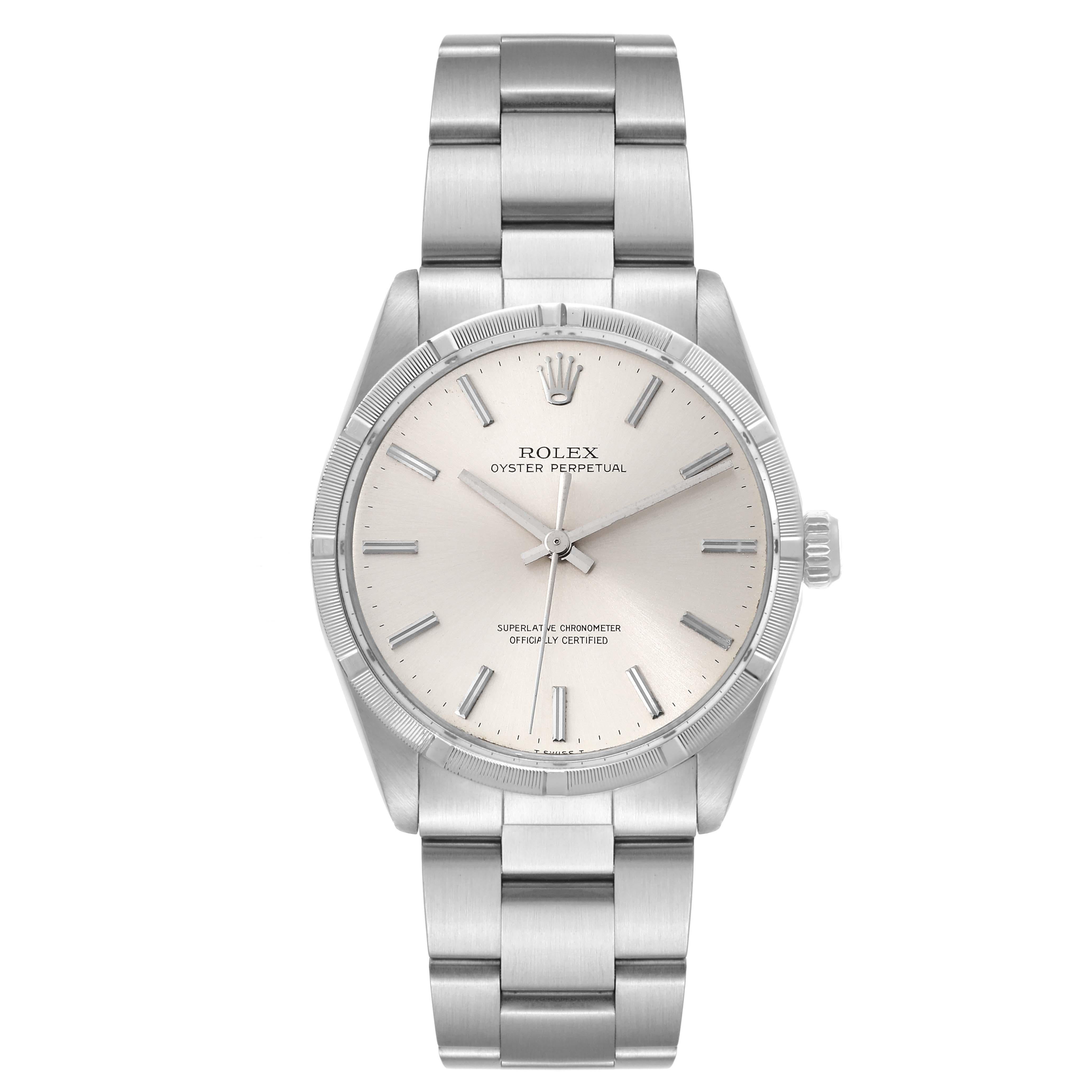 Rolex Oyster Perpetual Engine Turned Bezel Vintage Steel Mens Watch 1007. Officially certified chronometer automatic self-winding movement. Stainless steel oyster case 34.0 mm in diameter.  Rolex logo on the crown. Stainless steel engine turned
