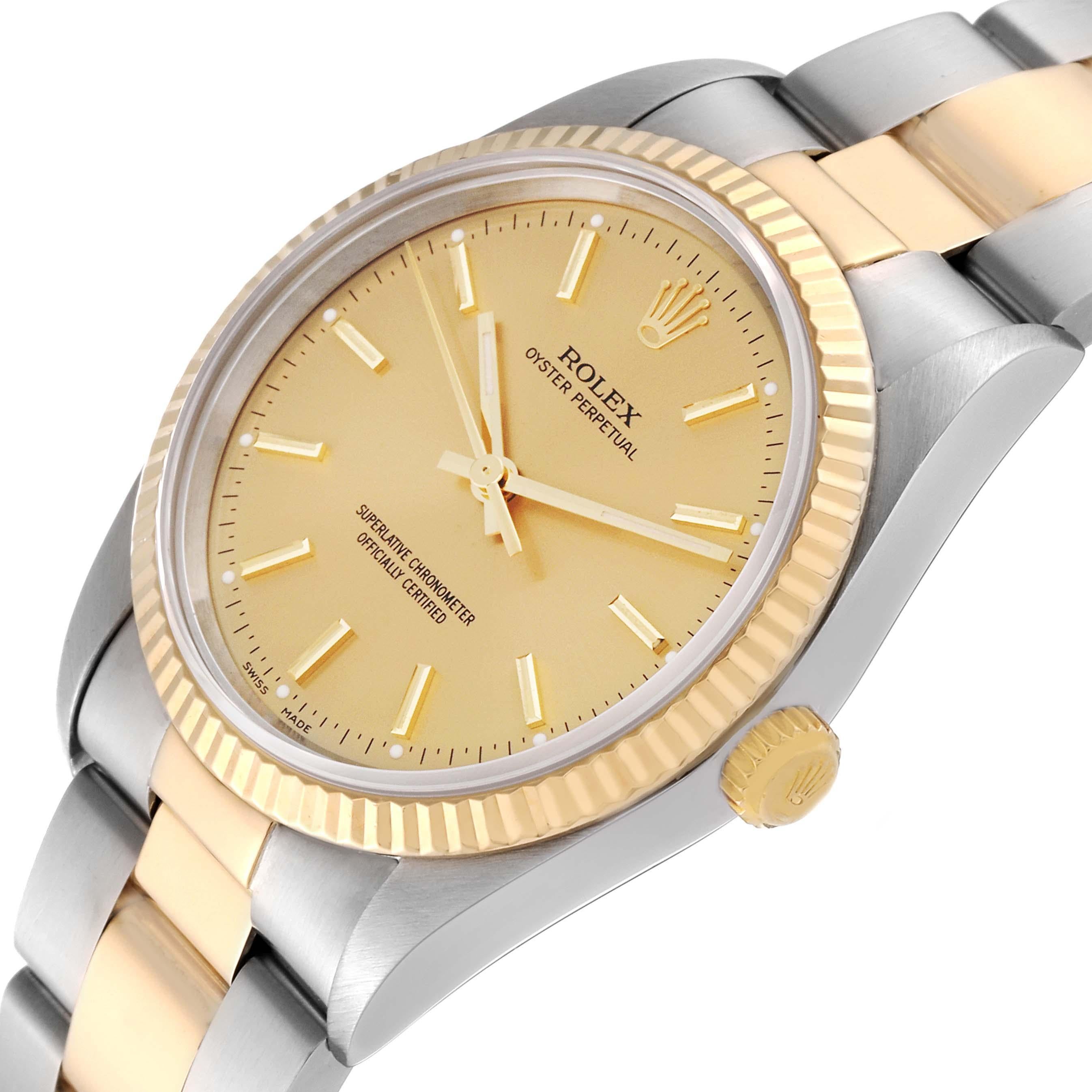 Rolex Oyster Perpetual Fluted Bezel Steel Yellow Gold Mens Watch 14233. Officially certified chronometer automatic self-winding movement. Stainless steel and 18K yellow gold oyster case 34.0 mm in diameter. Rolex logo on the crown. 18K yellow gold