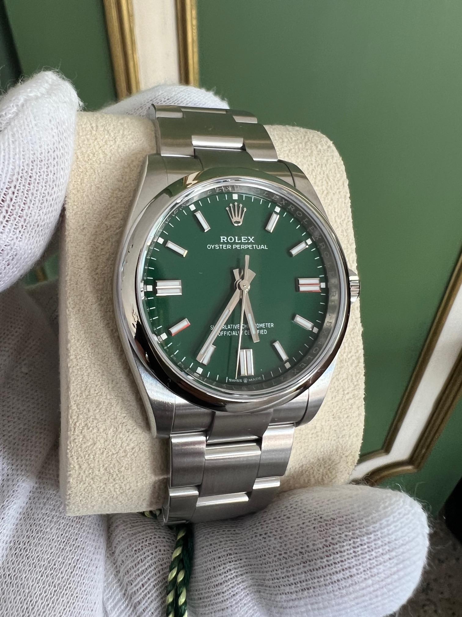 A beautiful, unworn, Rolex Oyster green dial, mens watch. Reference 126000 36mm, full set even includes the boutique green Rolex bag. Purchased February 6, 2023. Dial looks dark green or brighter green depending on lighting. We have been a 1stdibs