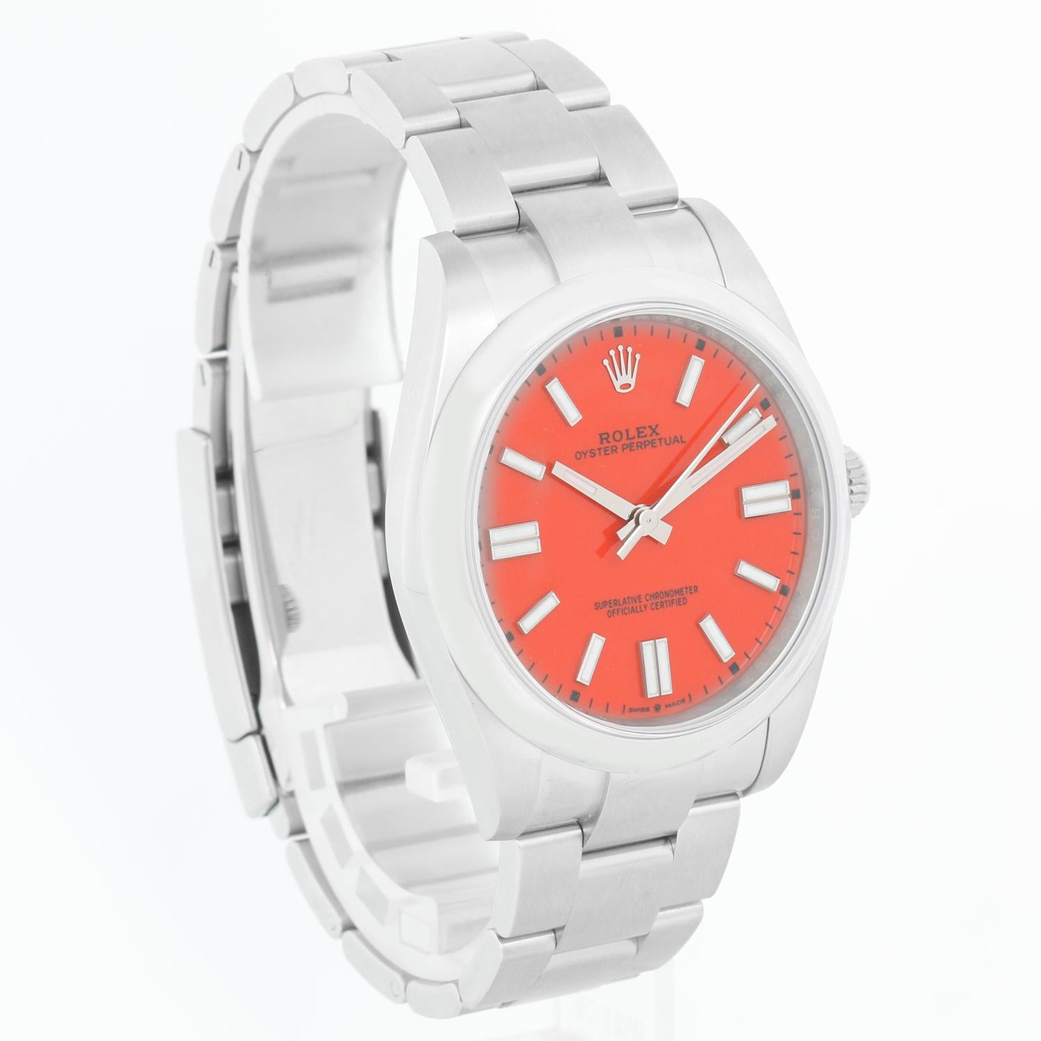 Rolex Oyster Perpetual Men's 41mm Coral Red Stainless Steel 124300 - Automatic winding, sapphire crystal. Stainless steel case (41mm diameter) with smooth bezel. Coral red dial with baton hour markers. Stainless steel Oyster bracelet. Unused Rolex