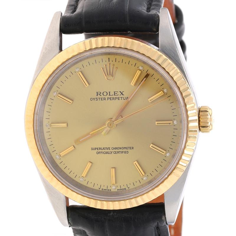 Brand: Rolex
Model: Oyster Perpetual
Model Number: 14233
Warranty: One Year
Year: 1995
Dial Color: Champagne

Metal Content: 18k Yellow Gold & Stainless Steel

Material Information
Genuine Leather Band
Color: Black

Fastening Type: Buckle