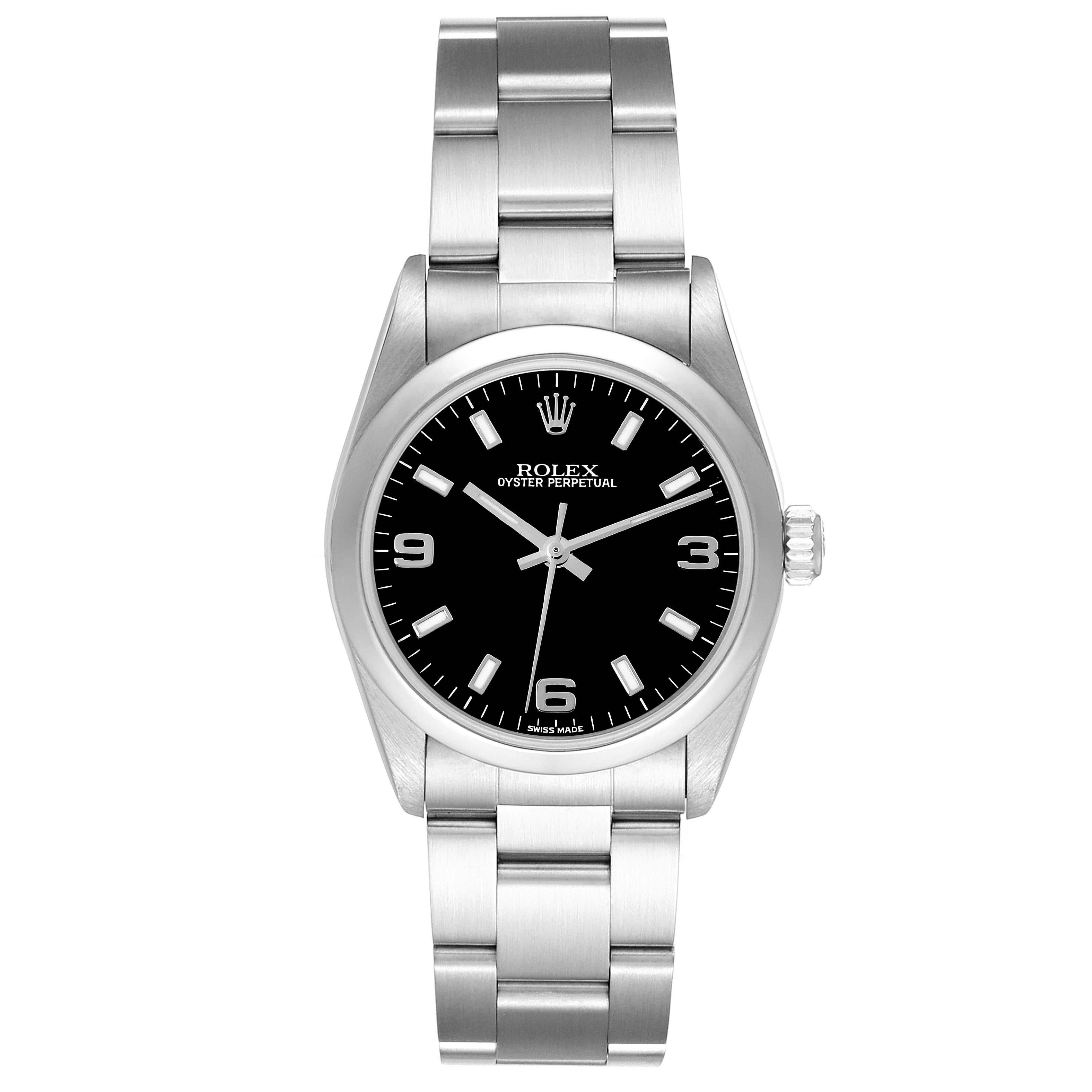 Rolex Oyster Perpetual Midsize Black Dial Steel Ladies Watch 77080. Officially certified chronometer automatic self-winding movement. Stainless steel oyster case 31.0 mm in diameter. Rolex logo on the crown. Stainless steel smooth bezel. Scratch