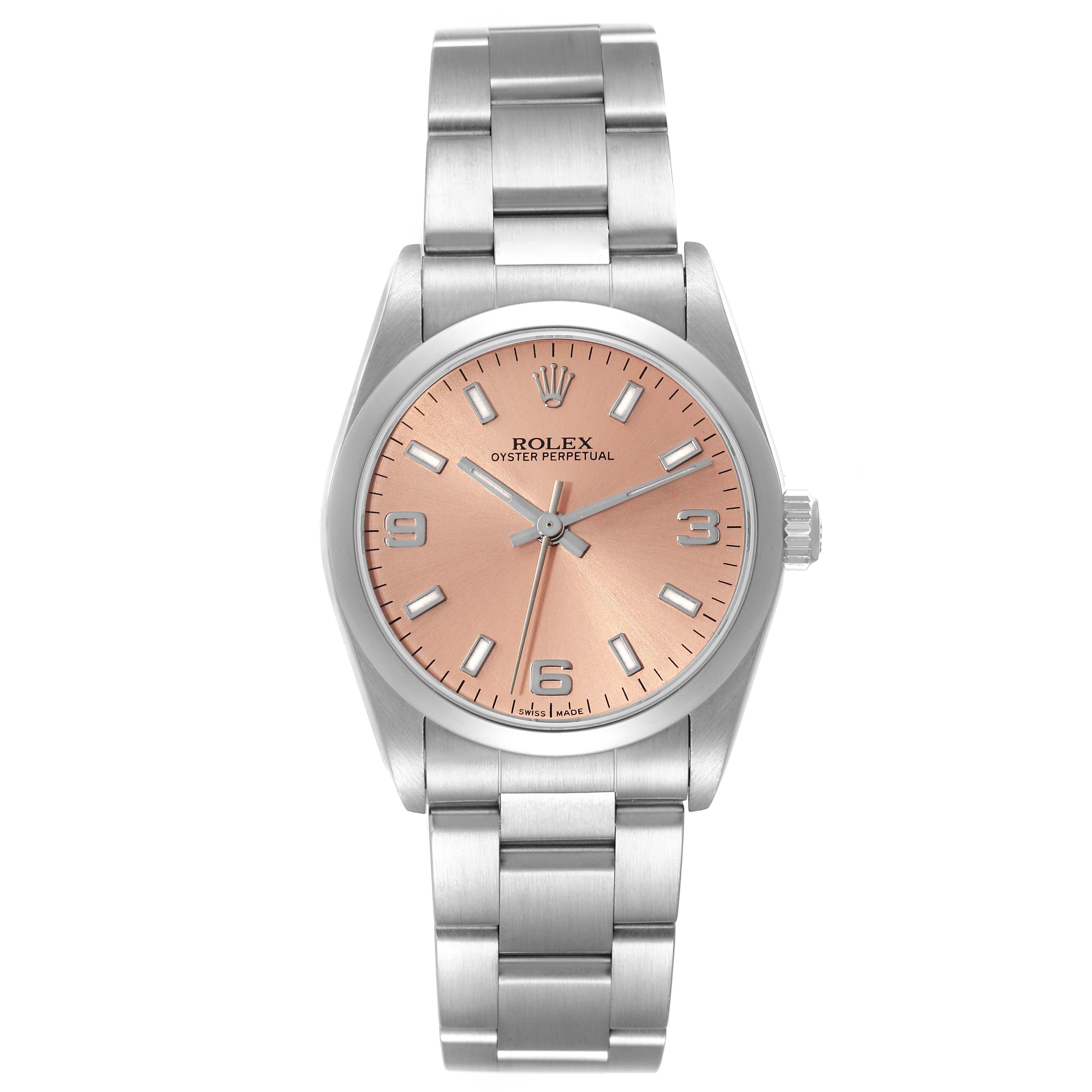 Rolex Oyster Perpetual Midsize Salmon Dial Steel Ladies Watch 77080 Box Papers. Officially certified chronometer automatic self-winding movement. Stainless steel oyster case 31.0 mm in diameter. Rolex logo on the crown. Stainless steel smooth bezel.