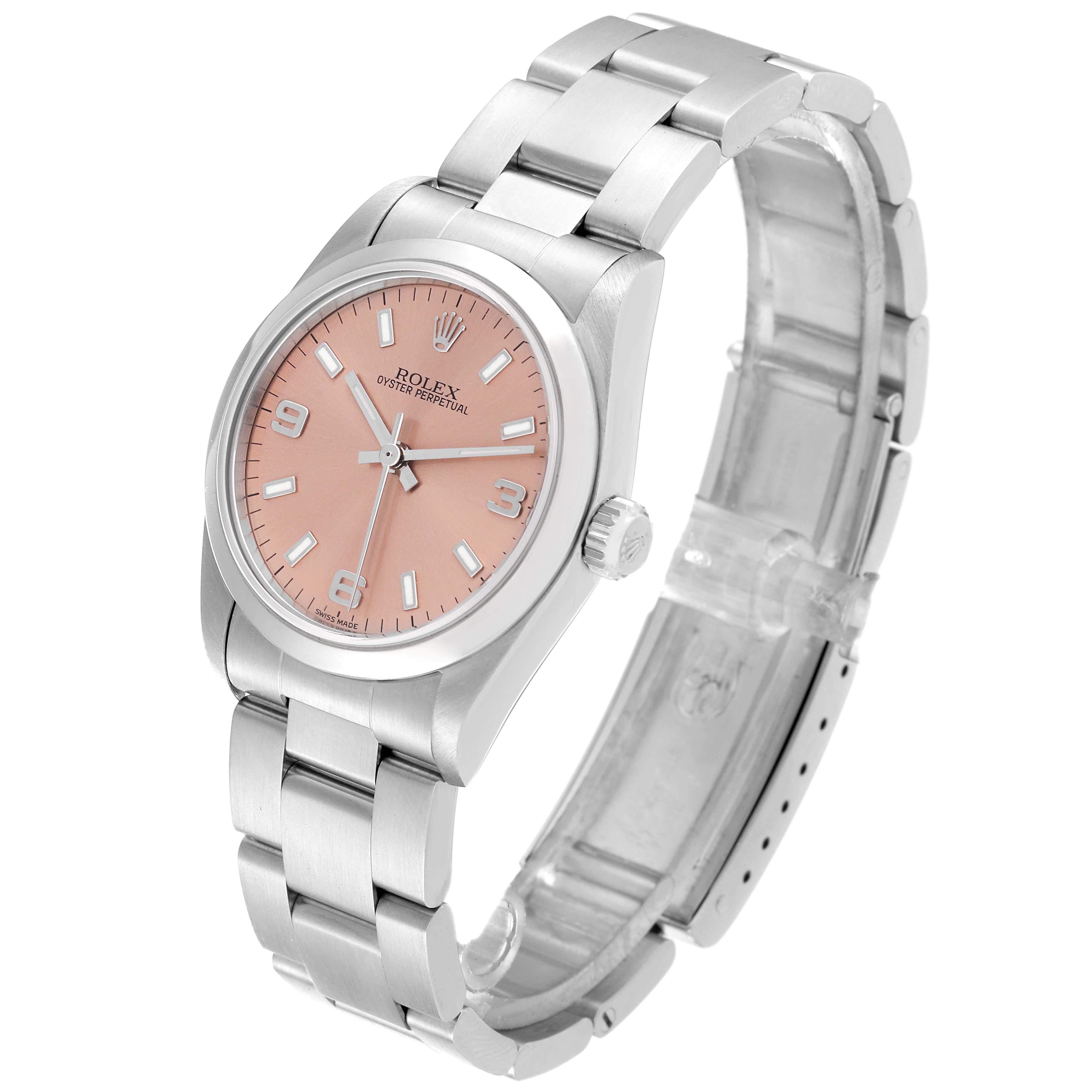 Rolex Oyster Perpetual Midsize Salmon Dial Steel Ladies Watch 77080. Officially certified chronometer automatic self-winding movement. Stainless steel oyster case 31.0 mm in diameter. Rolex logo on the crown. Stainless steel smooth bezel. Scratch