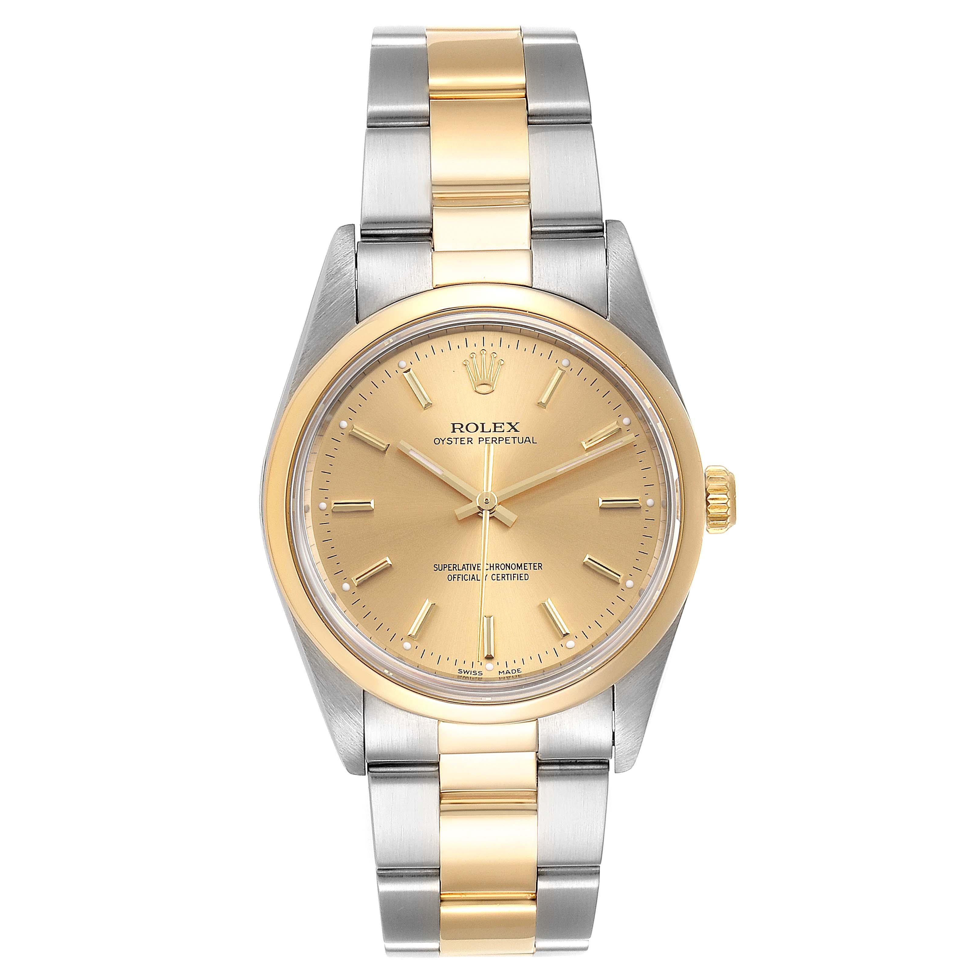 Rolex Oyster Perpetual Nondate Steel Yellow Gold Mens Watch 14203. Officially certified chronometer self-winding movement. Stainless steel and 18K yellow gold oyster case 34.0 mm in diameter. Rolex logo on a crown. 18K yellow gold smooth domed