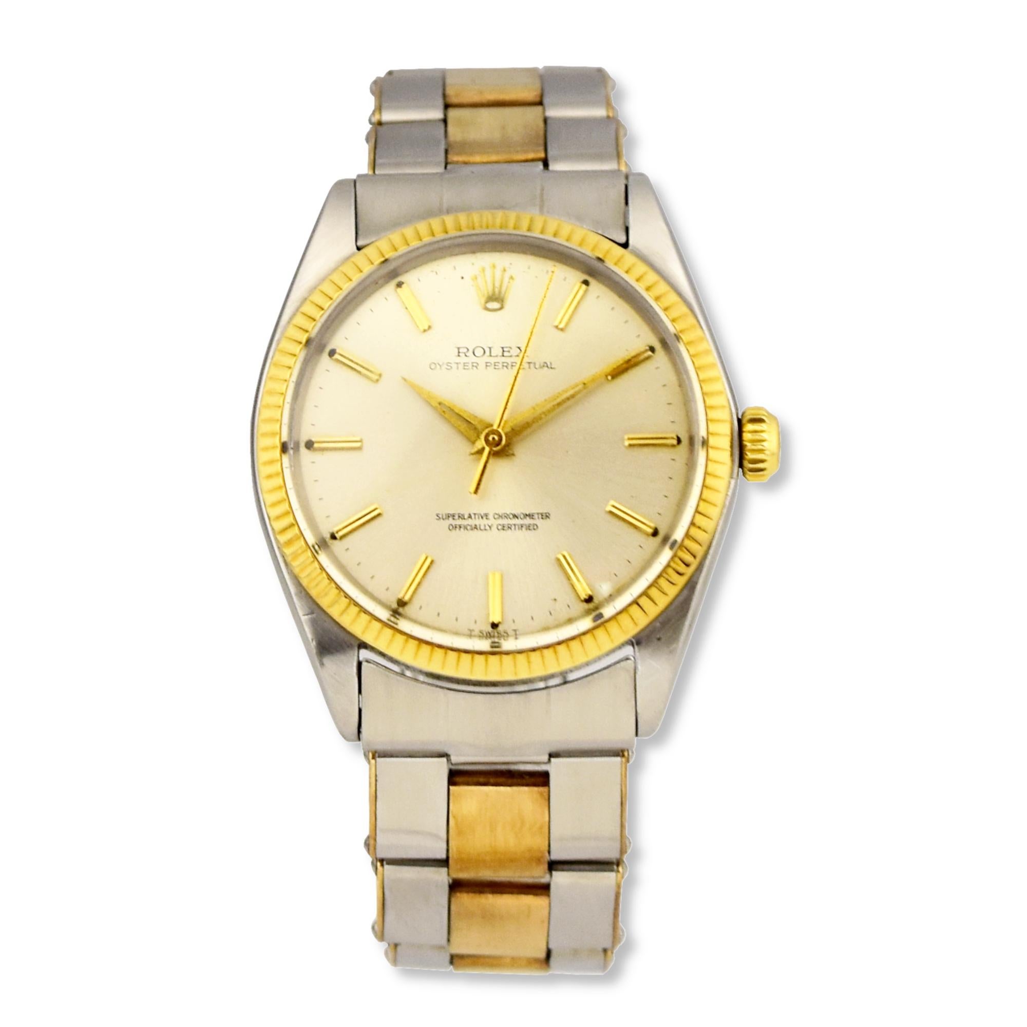 Brand: Rolex
Model Name: Oyster Perpetual
Model Number:  1005
Movement: Automatic
Case Size: 34 mm
Case Back: Solid
Case Material: Stainless Steel; Yellow Gold
Bezel: Yellow Gold
Dial: Silver
Bracelet:  Oyster; Yellow Gold; Steel
Hour Markers: Non