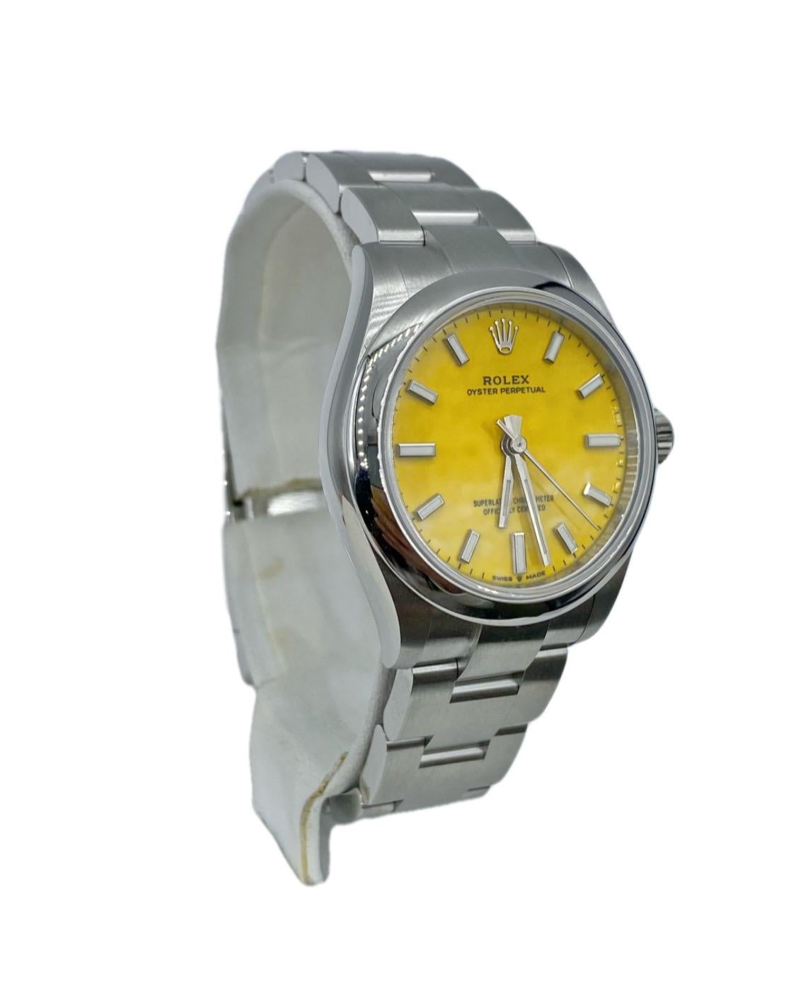 Unworn Rolex Oyster Perpetual 277200-0005, 31 mm. The watch has Yellow Dial. The Case is Oystersteel w/ 2232 Movement, 55 hours power reserve. The Bracelet Oystersteel with Folding Oysterclasp with Easylink 5 mm comfort extension link. The