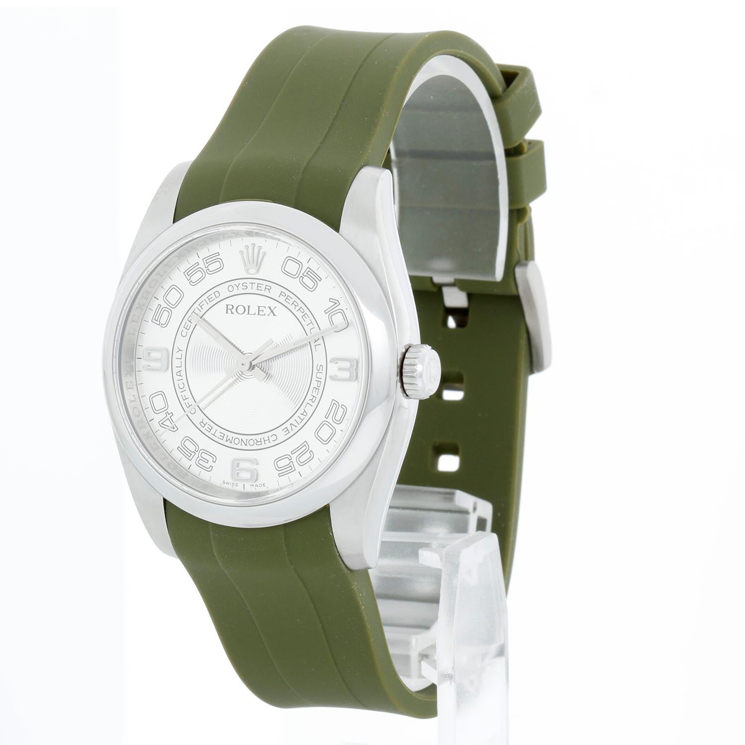 Rolex Oyster Perpetual Stainless Steel  Men's Watch 116000 with Rubber Strap  - Automatic winding, 31 jewels, sapphire crystal. Stainless steel case with smooth bezel (36mm diameter). Silver concentric circles with silver Arabic numerals. Green