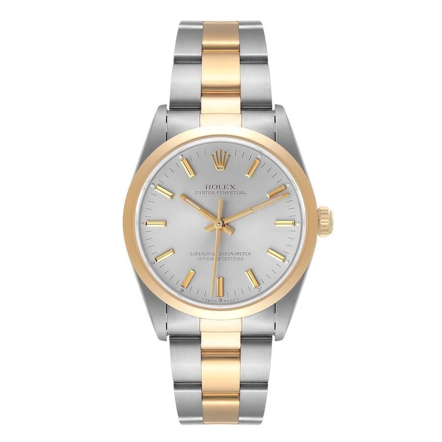 Rolex Oyster Perpetual Steel Yellow Gold Silver Dial Mens Watch 14203. Officially certified chronometer self-winding movement. Stainless steel and 18K yellow gold oyster case 34.0 mm in diameter. Rolex logo on a crown. 18K yellow gold smooth domed
