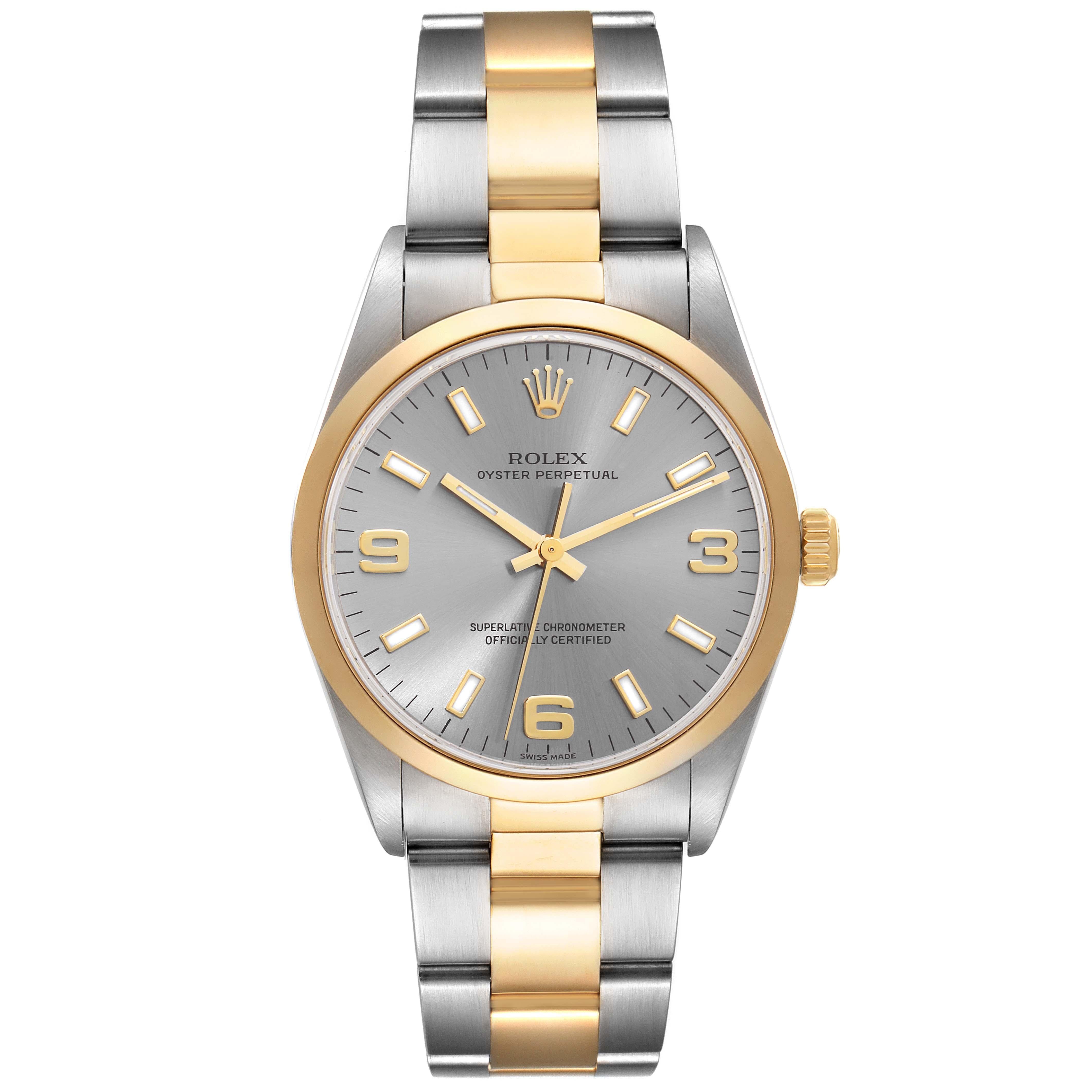 Rolex Oyster Perpetual Steel Yellow Gold Slate Dial Mens Watch 14203 Box Papers. Officially certified chronometer automatic self-winding movement. Stainless steel and 18K yellow gold oyster case 34.0 mm in diameter. Rolex logo on the crown. 18K