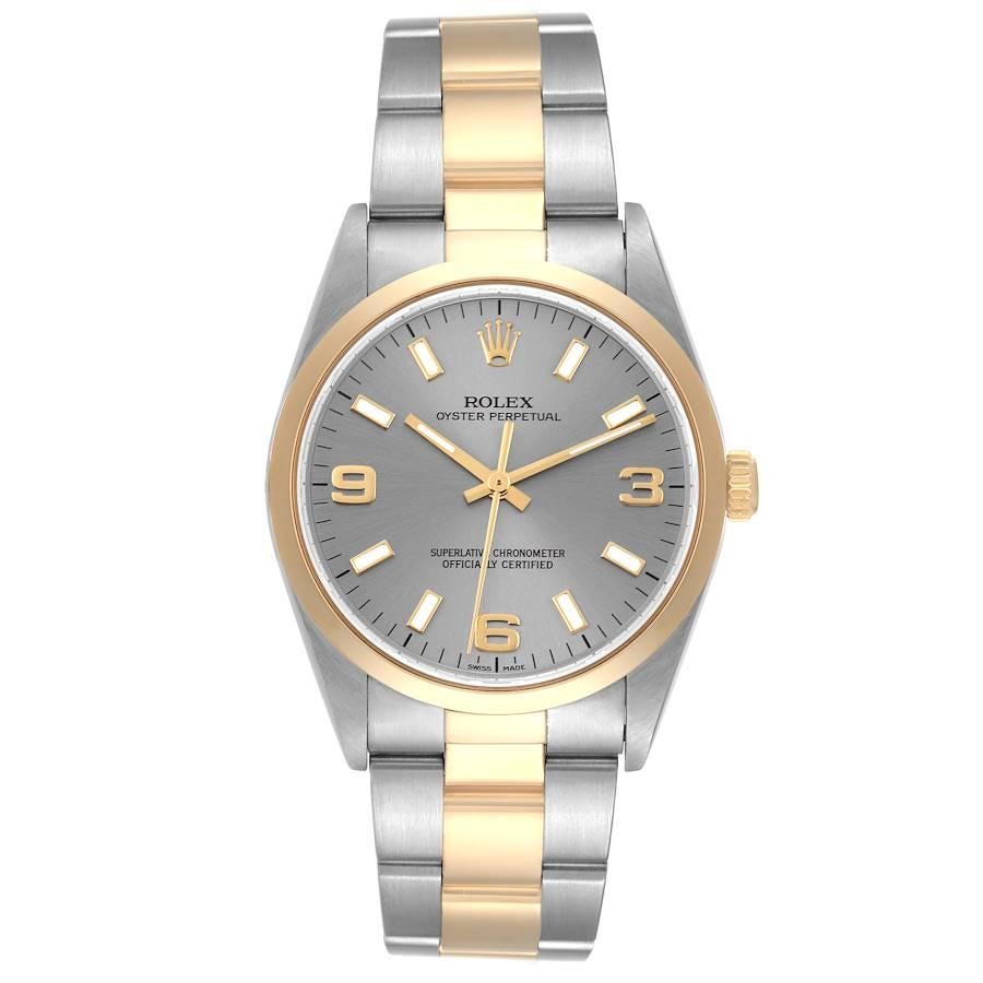 Rolex Oyster Perpetual Steel Yellow Gold Slate Dial Mens Watch 14203. Officially certified chronometer automatic self-winding movement. Stainless steel and 18K yellow gold oyster case 34.0 mm in diameter. Rolex logo on the crown. 18K yellow gold
