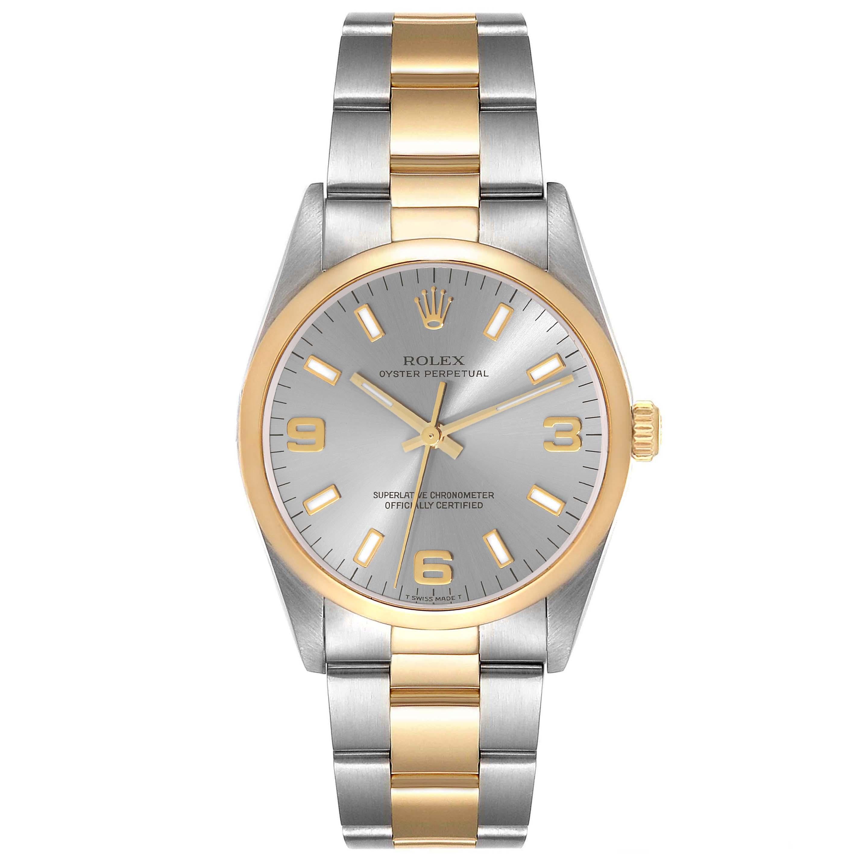 Rolex Oyster Perpetual Steel Yellow Gold Slate Dial Mens Watch 14203. Officially certified chronometer automatic self-winding movement. Stainless steel and 18K yellow gold oyster case 34.0 mm in diameter. Rolex logo on the crown. 18K yellow gold