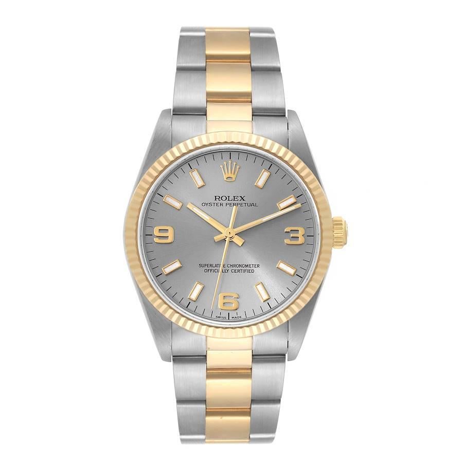 Rolex Oyster Perpetual Steel Yellow Gold Slate Dial Mens Watch 14233. Officially certified chronometer self-winding movement. Stainless steel and 18K yellow gold oyster case 34.0 mm in diameter. Rolex logo on a crown. 18K yellow gold fluted bezel.