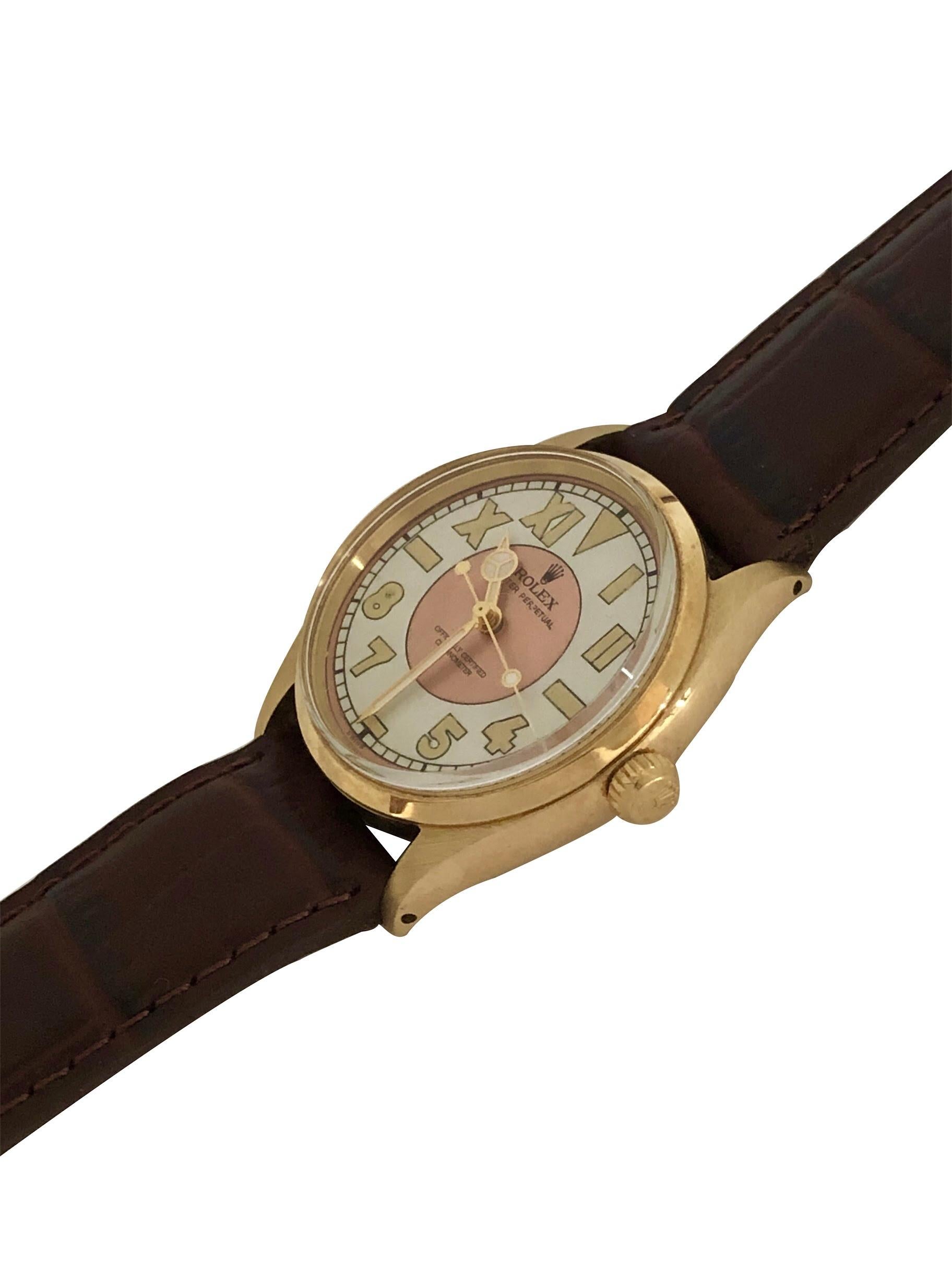 Circa 1945 Rolex Oyster Perpetual Reference 6567 Wrist Watch, 34 M.M 14K yellow Gold 3 piece case with smooth bezel. Caliber 1030 Automatic, self winding Nickle lever movement, Gold Rolex Logo Crown.  Custom Rose and White 