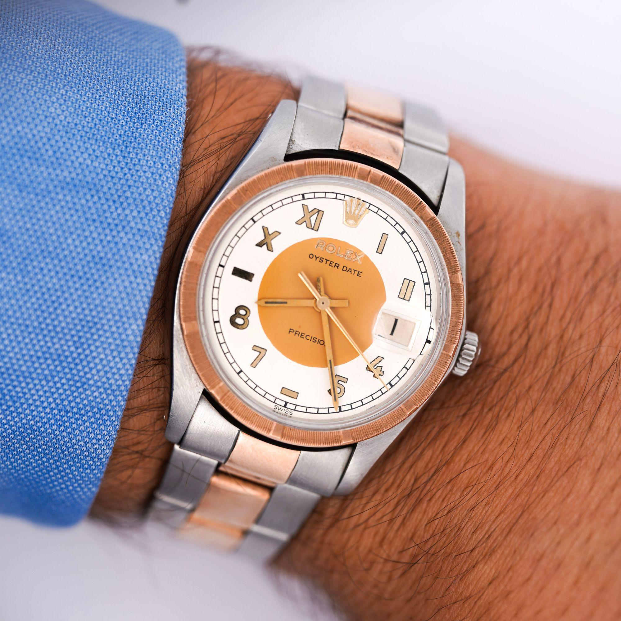 Rolex Precision Oyster Date 34mm on two tone rose gold and stainless steel on Oyster bracelet. The dial features a rare brown and cream white pattern, complemented by a seldom seen mix of arabic and roman numeral hour markers. The combination of