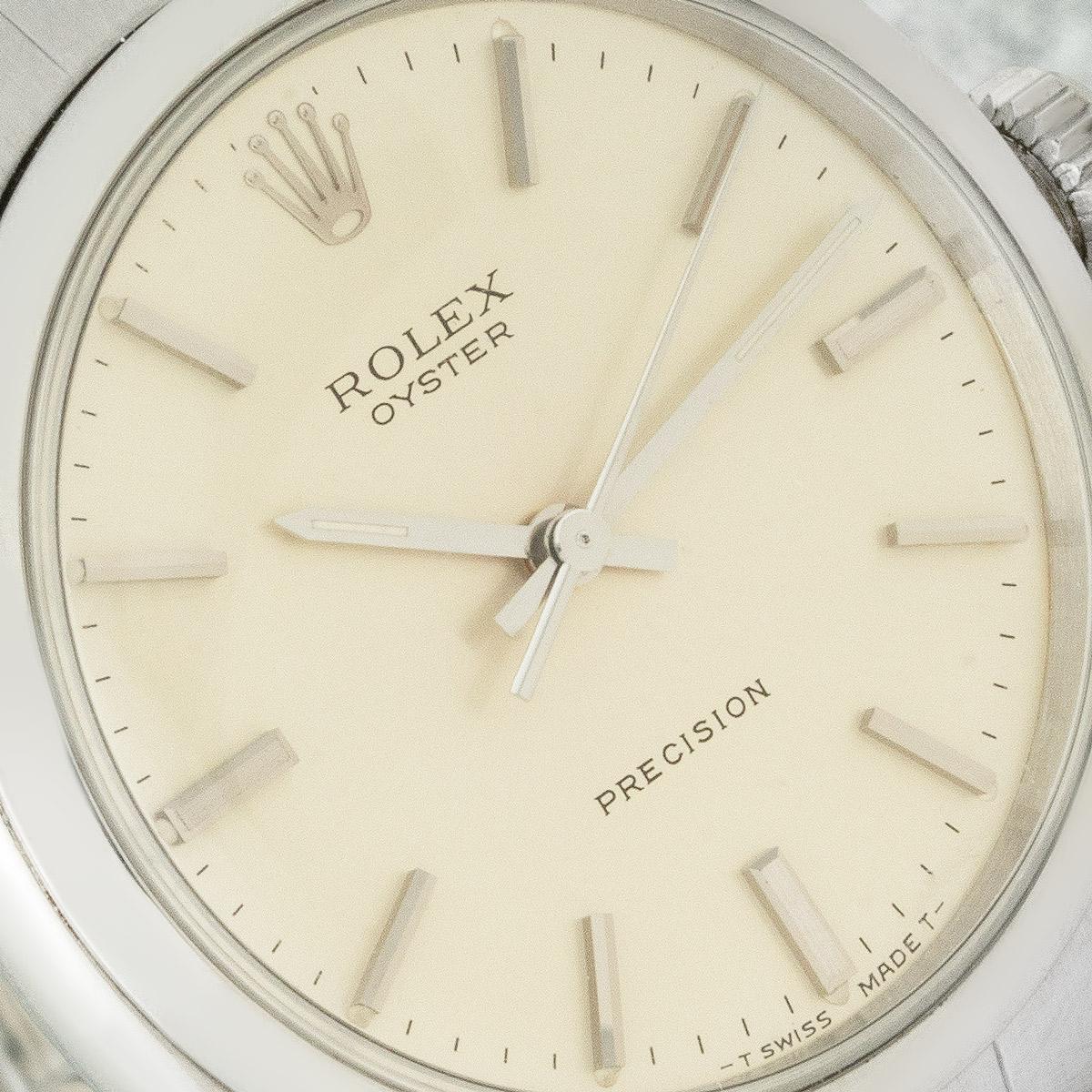 A 34mm Precision watch by Rolex crafted in stainless steel. Featuring a silver dial with applied hour markers and a smooth steel bezel. The watch is fitted with a plexiglass, a manual winding movement and a steel riveted bracelet equipped with a