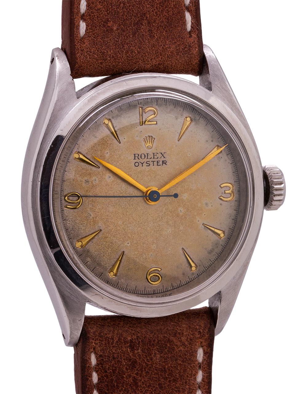 
Rolex Oyster ref # 6022 in stainless steel, case serial # 761,xxx circa 1951. Featuring 34mm diameter case with smooth bezel and very pleasing patina’d original dial with gold embossed numeral and arrow indexes, and tapered gilt leaf style hands.
