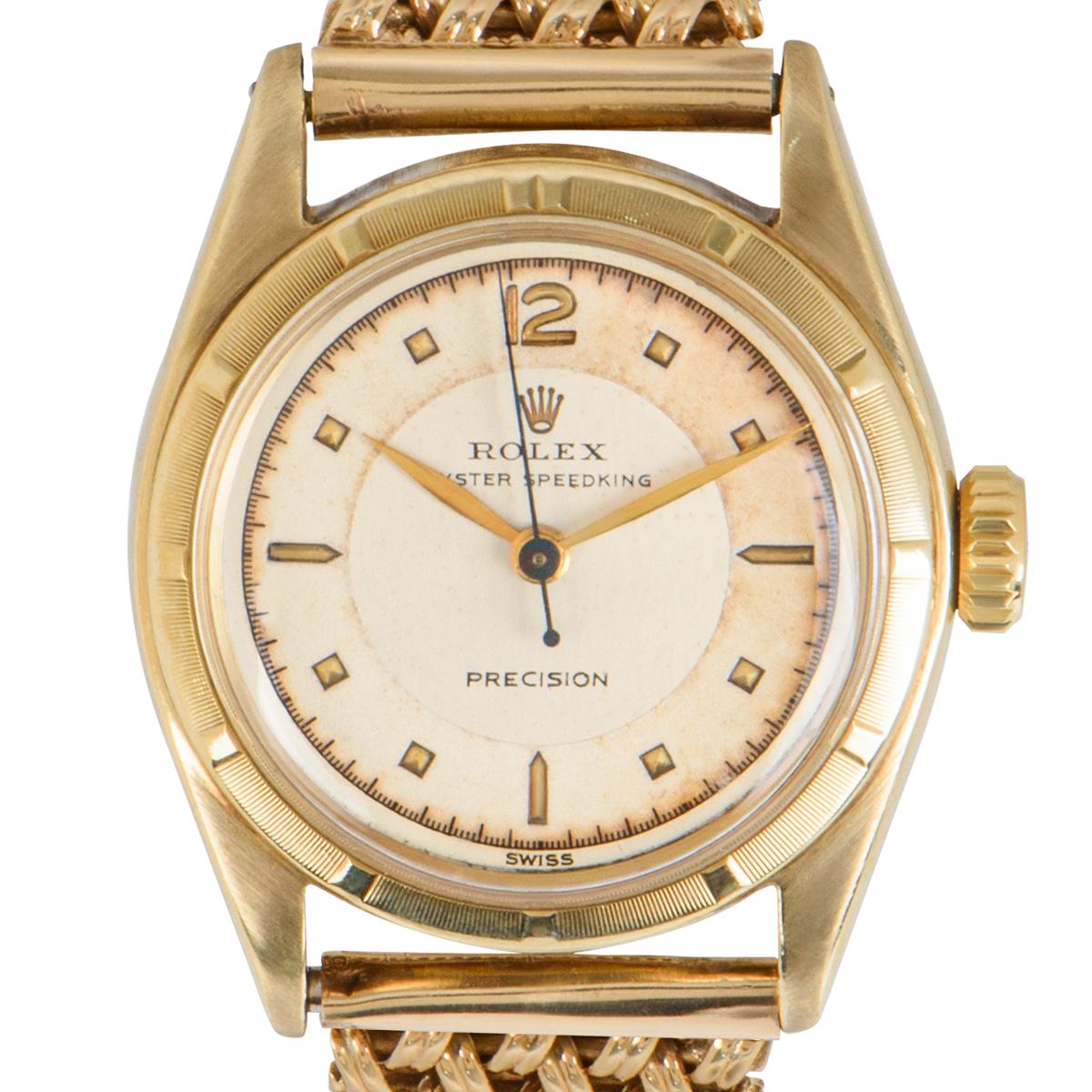 A mens mid-size Oyster Speedking Precision wristwatch in yellow gold by Rolex. Featuring a silver and cream dial with a fixed yellow gold bezel. Equipped with a 9k yellow gold bracelet (not from Rolex) set with a jewellery clasp. The watch is fitted