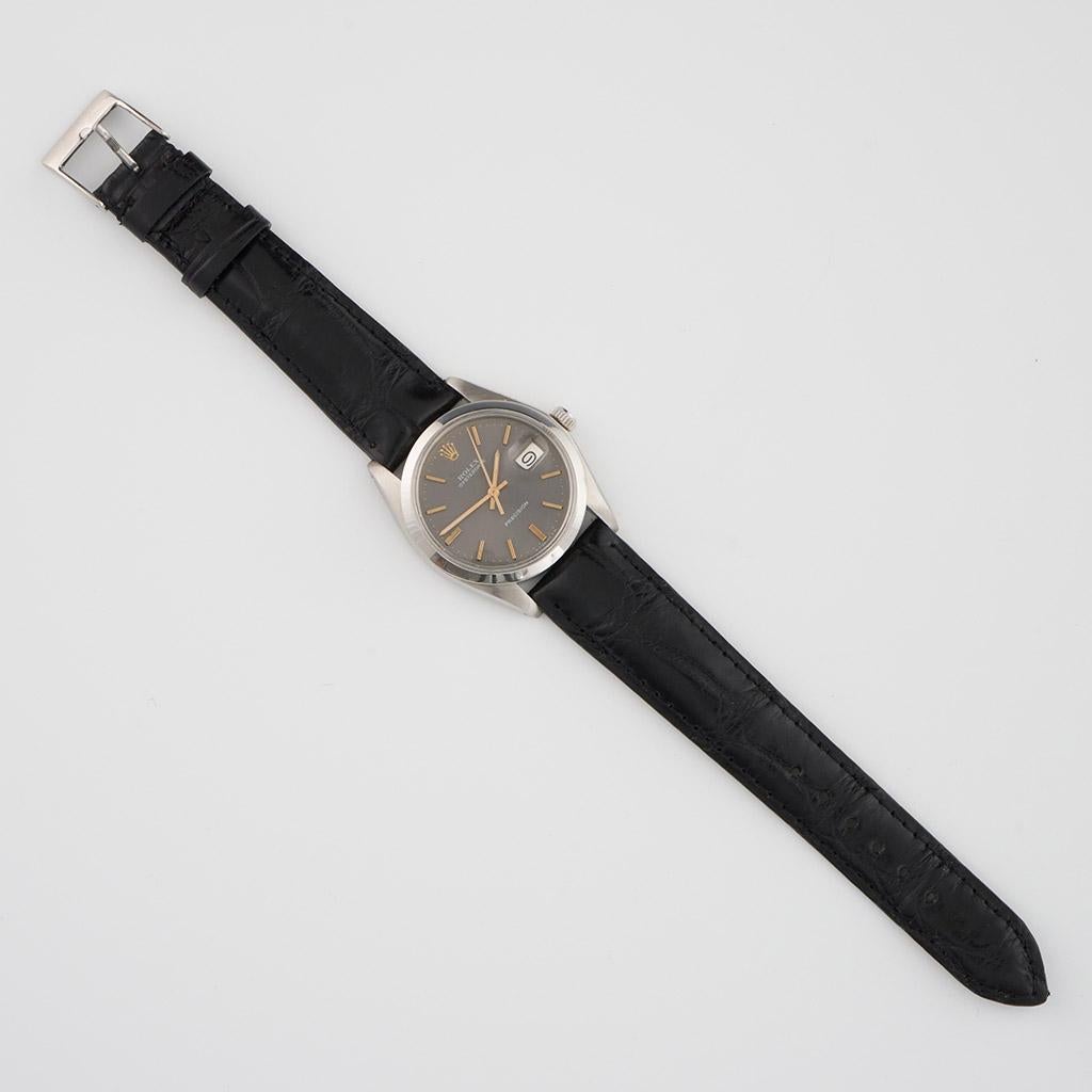 Rolex Oysterdate Precision Mens Wristwatch. Steel, grey dial and manual wind. Serial number 3.899.874. 

Origin: Swiss

Date, Circa 1974

Item Number: 1011231/1169