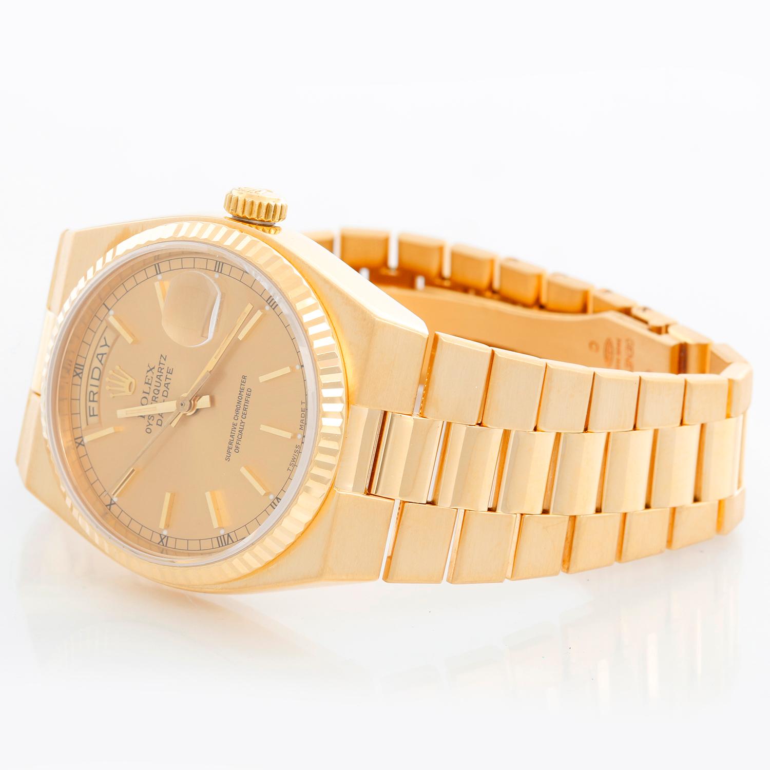 Rolex Oysterquartz Day-Date Men's 18K Gold Watch 19018 - Quartz; quick-set; sapphire crystal. 18k yellow gold case with fluted bezel (36mm diameter). Champagne stick dial. 18k yellow gold Oysterquartz hidden-clasp bracelet. Pre-owned with custom