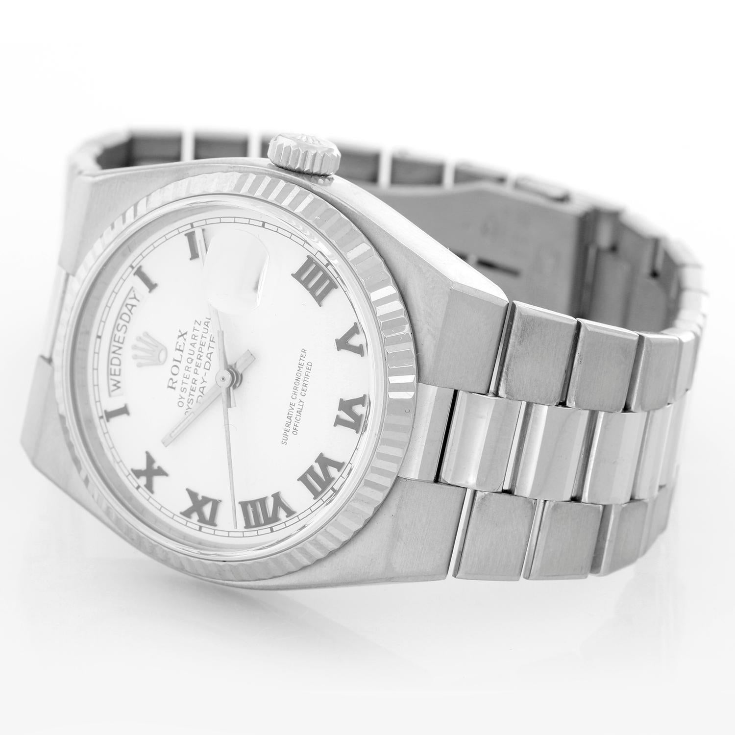 Rolex Oysterquartz Day-Date Men's 18K White Gold President Watch 19019 - Quartz; quick-set; sapphire crystal. 18k white gold case with fluted bezel (36mm diameter). White dial with raised gold Roman numerals. 18k white gold Oysterquartz hidden-clasp