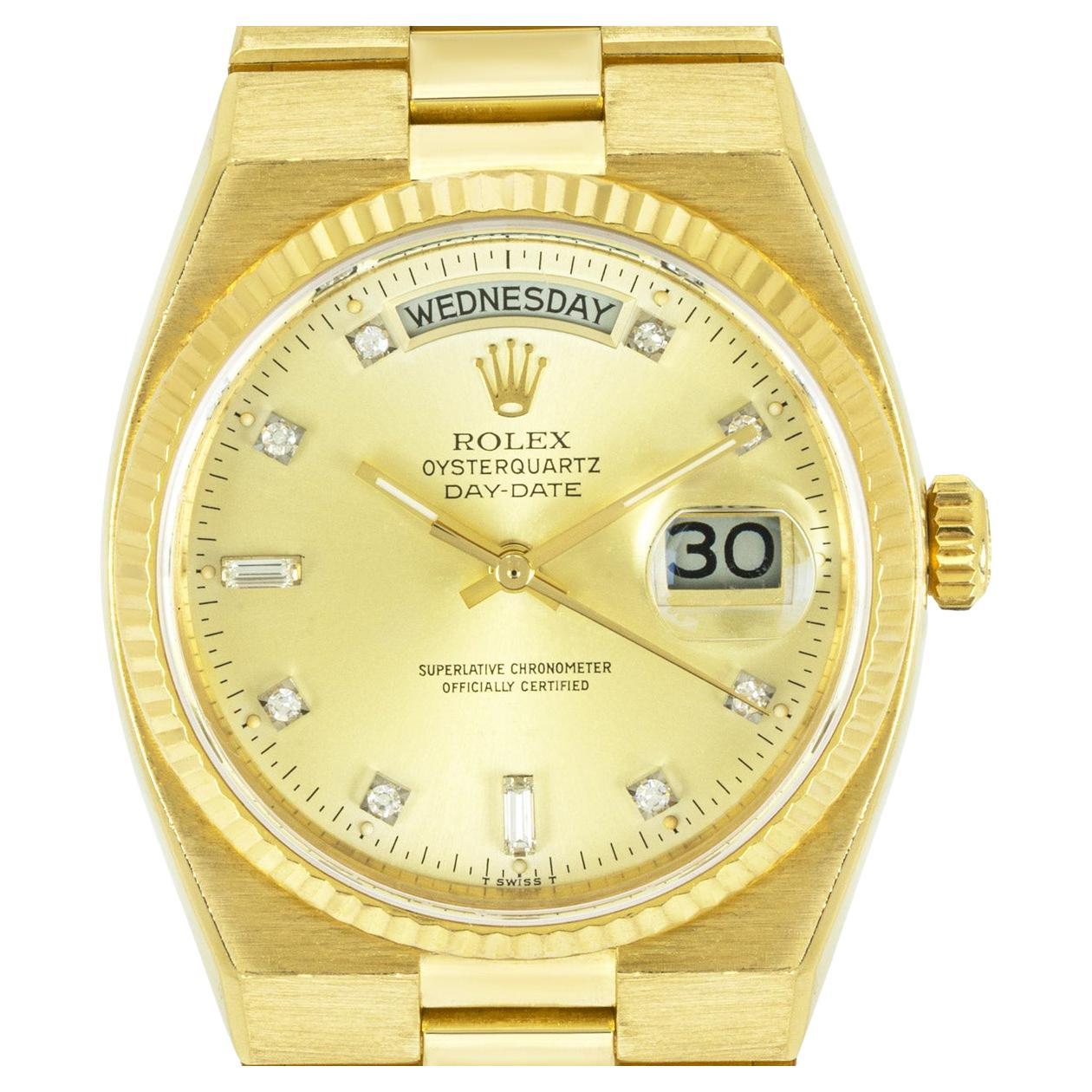 A mens 36mm Day-Date Oysterquartz in yellow gold by Rolex. Featuring a champagne dial with diamond set hour markers and a fixed fluted yellow gold bezel.

Fitted with a sapphire glass, Oysterquartz movement and an 18k yellow gold Oysterquartz