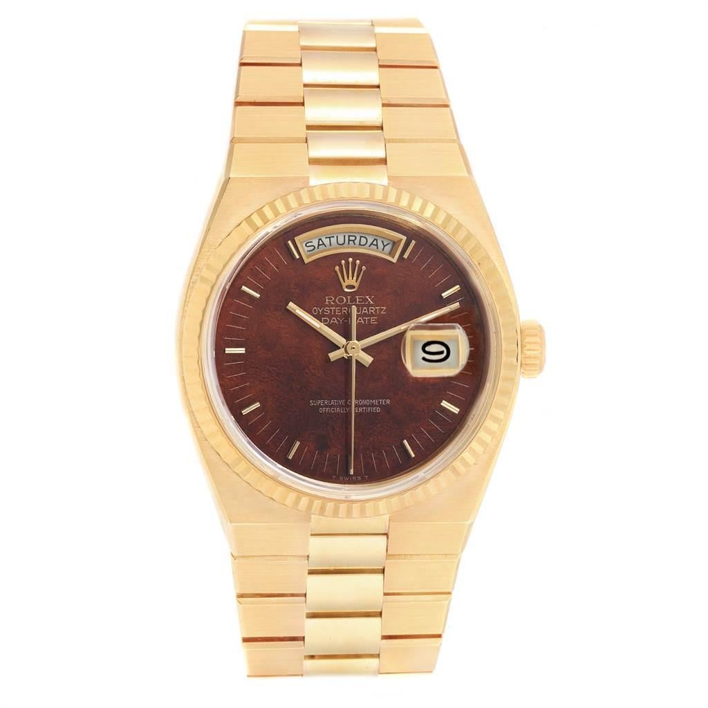 Rolex Oysterquartz President Day Date Yellow Gold Burlwood Watch 19018. Quartz movement. 18K yellow gold oyster case 36.0 mm in diameter. Rolex logo on a crown. 18k yellow gold fluted bezel. Scratch resistant sapphire crystal with cyclops magnifier.