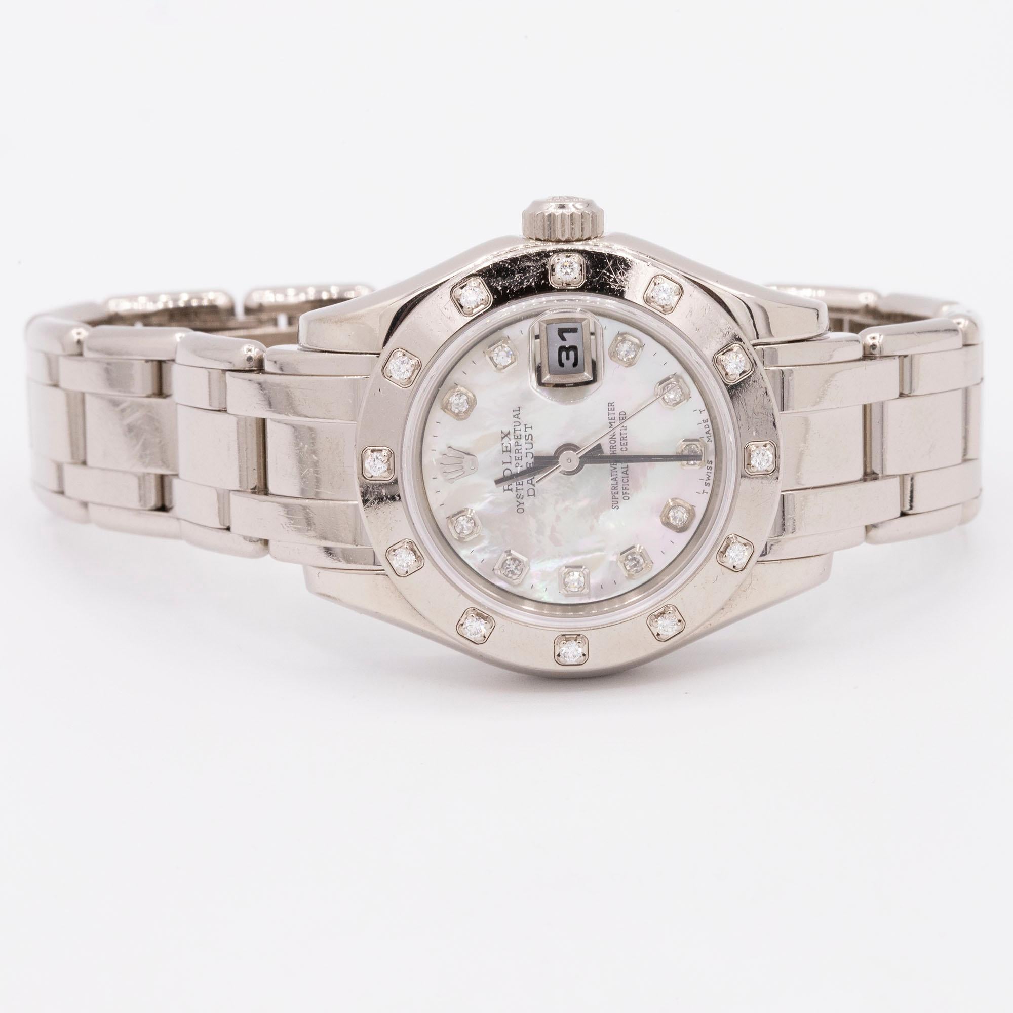 18kt White Gold Rolex Pearlmaster. This piece has a mother-of-pearl diamond dial and a scattered diamond bezel. The timepiece features a date at the 3 o'clock position with a cyclops lens. Model # 80319. Calibre # 2235. CIRCA 1999.