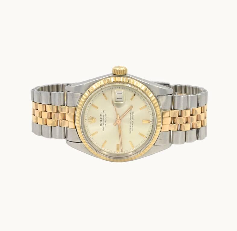 This is a very rare Rolex wristwatch in a very limited pink gold, reference 1601 from 1973. This watch has a rare pink gold jubilee bracelet, a pink gold fluted bezel, silver colored original pipe hand style dial with pink markers, plastic crystal,