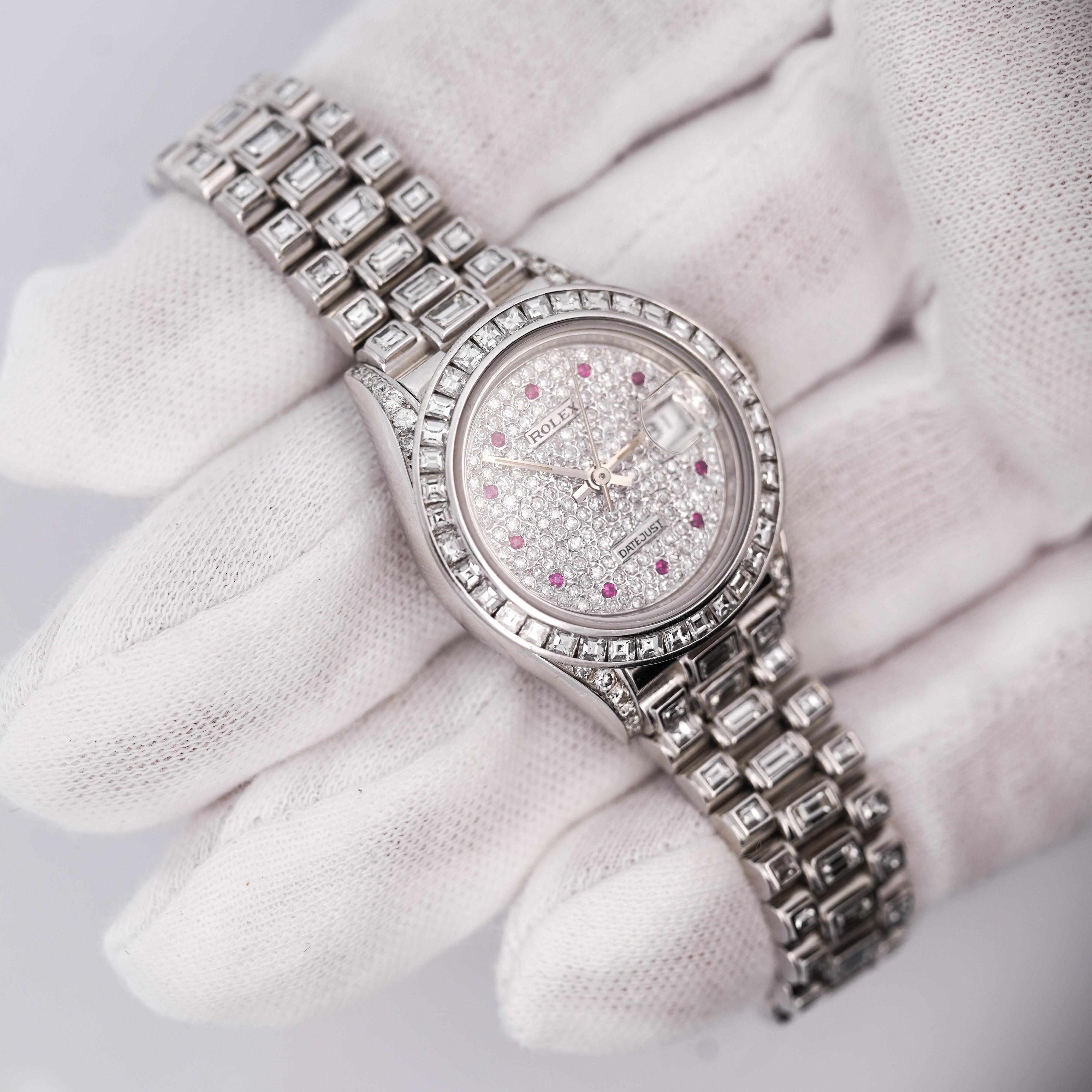 Vintage 1988 Rolex Datejust Presidential in platinum featuring 15 carats of natural diamonds. Pave diamond dial and pink ruby hour markers. Emerald/baguette cut diamond bezel and bracelet. Reference 69166, in excellent working condition, fully