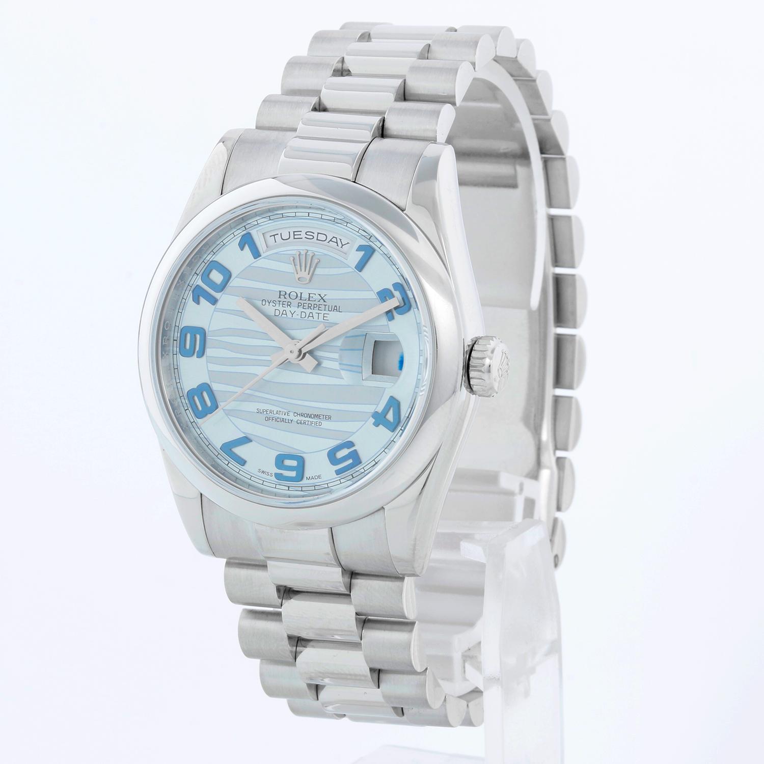 Rolex Platinum President  Day-Date Men's Watch 118206 - Automatic winding, 31 jewels, Quickset, sapphire crystal. Platinum case with smooth bezel . Glacier blue wave dial . Platinum hidden clasp President bracelet. Pre-owned with box and books.