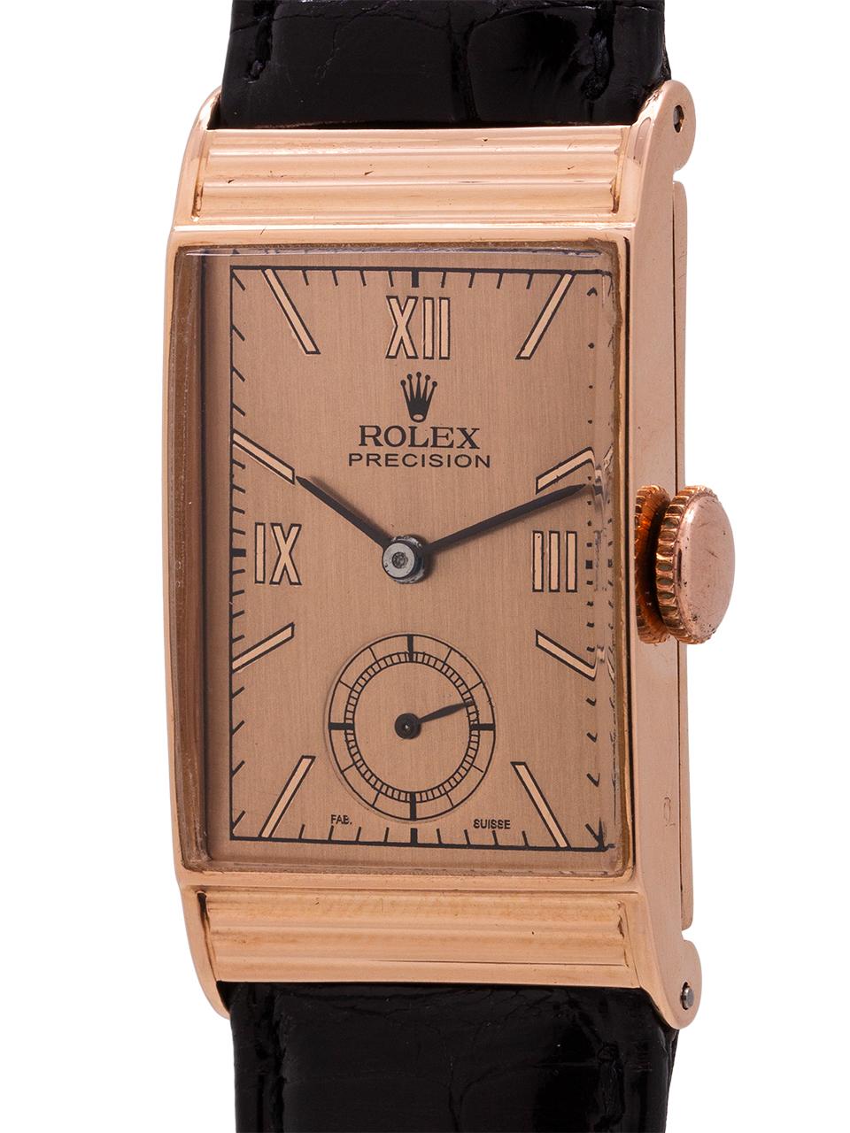 
Vintage Rolex Precision man’s 14K PG manual wind dress model ref 4010 circa 1940’s. Featuring a 20 x 33mm rectangular case with styliized ribbed hooded lug design and beautifully restored antique salmon dial with mirror rose Roman indexes and