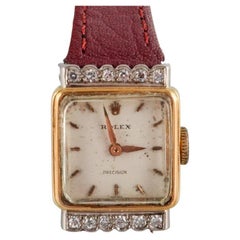 Rolex, Precision. 18-carat gold ladies' wristwatch set with twelve diamonds. 