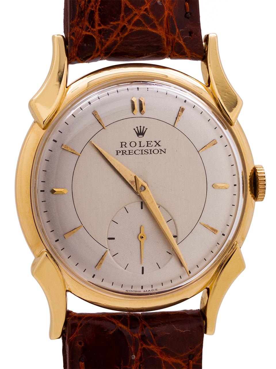 
Rolex Precision 18K YG man’s manual wind dress model ref. 4477 circa 1955. A very attractive medium sized dress model featuring a 33mm snap back case highly stylized and curved lugs, with a smooth, sloped gold bezel, and low dome acrylic crystal.