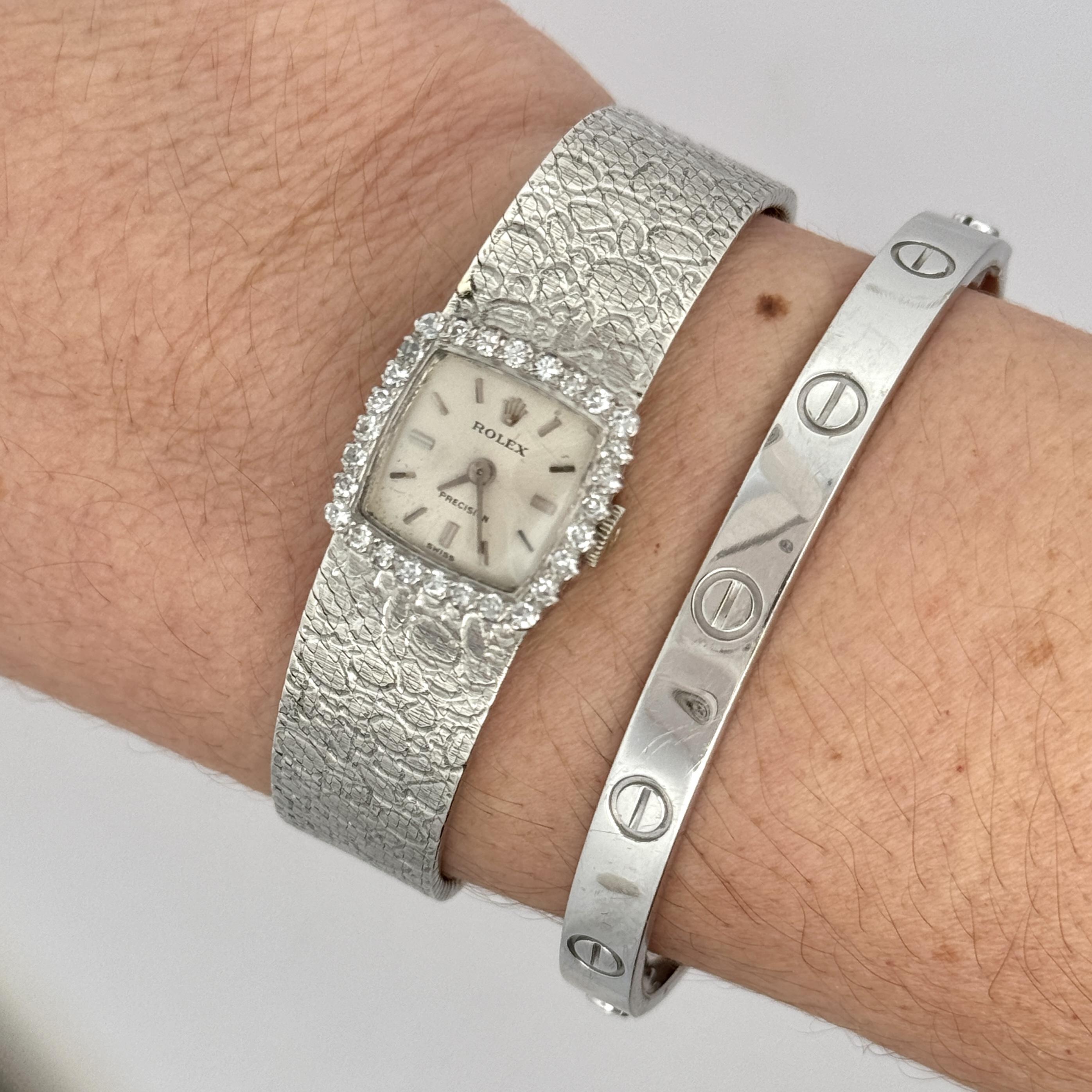 18K white gold Rolex Precision Swiss made watch features an elegant, square dial encircled by a diamond bezel, enhancing its timeless appeal. A unique mesh band with an alligator motif textured white gold bracelet. An extremely unique Rolex that you