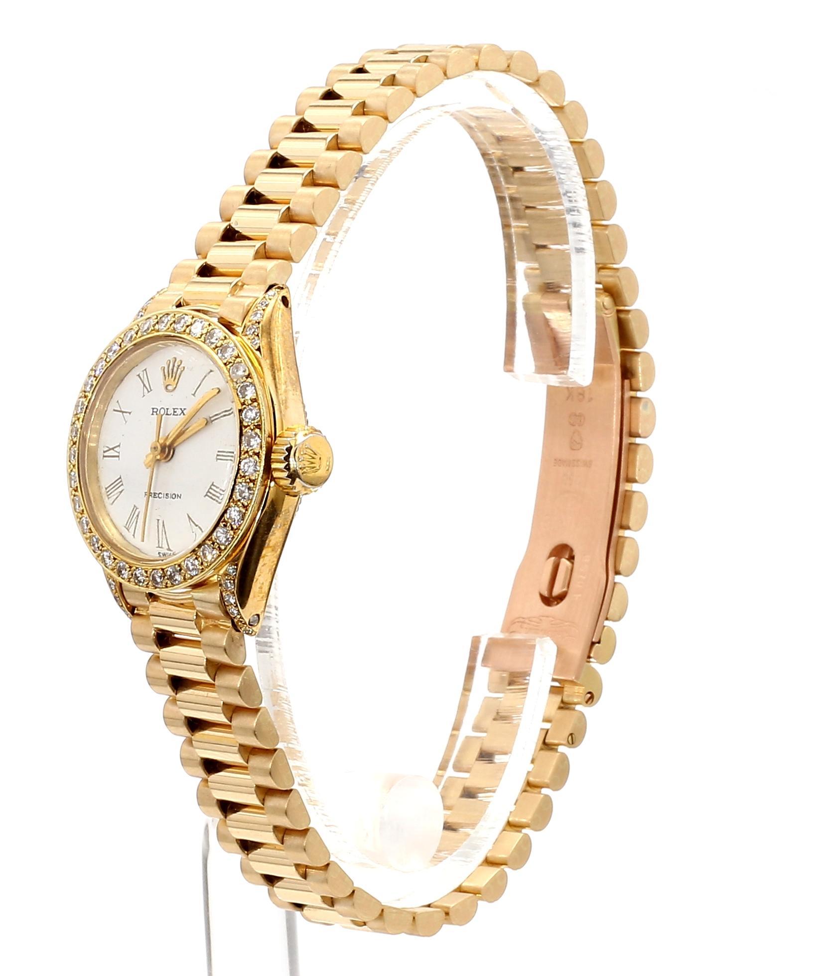 Vintage Rolex Precision manual-wind watch in 18K yellow gold featuring a 22mm round case with aftermarket diamond bezel and Roman numeral dial. 18k Gold President bracelet with high-polish finish. 7.25 Inch length. 

The movement is a Tudor