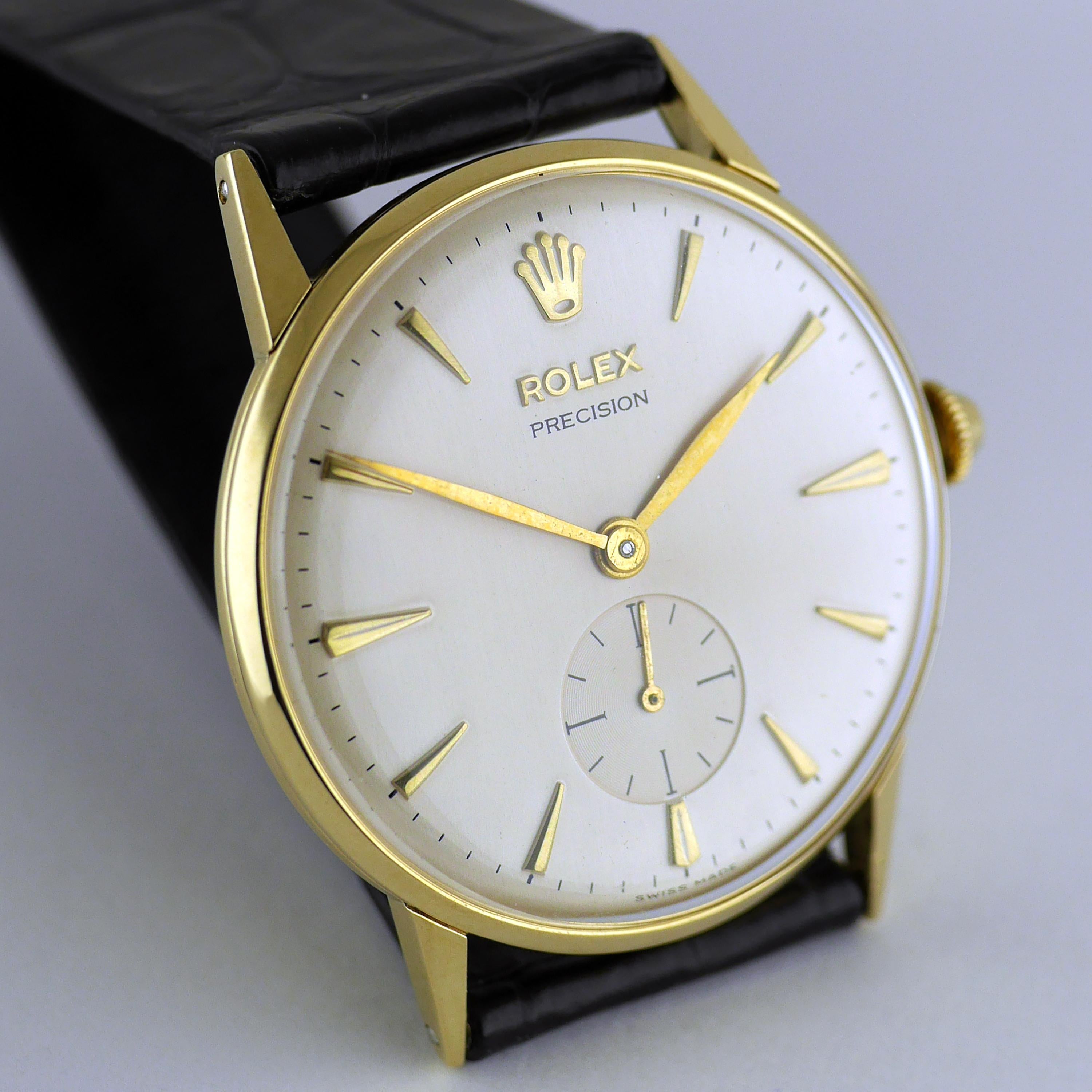 Vintage Rolex Precision wristwatch, circa 1959.

Snap back 18 carat gold case with tapered fancy lugs.

Rolex, 17-Rubies (Jewels) precision lever escapement movement with Superbalance. Subsidiary seconds.

Silvered dial with raised gold tapered,