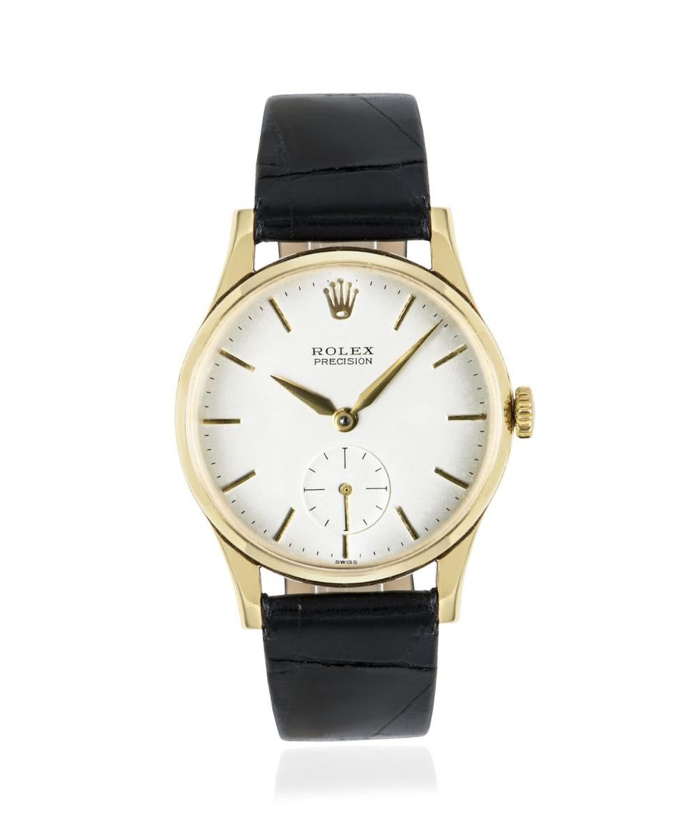 A 9k yellow gold vintage 31mm Precision by Rolex, featuring its original silver dial with a small seconds display at 6 o'clock. The generic black leather strap is brand new and comes with a Rolex gold plated pin buckle. Fitted with plastic glass and