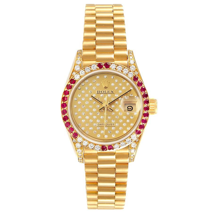 Rolex President 26 Yellow Gold Pave Diamond Ruby Ladies Watch 69038. Officially certified chronometer self-winding movement with quickset date function. 18k yellow gold oyster case 26.0 mm in diameter.  Rolex logo on a crown. Diamond lugs. Original