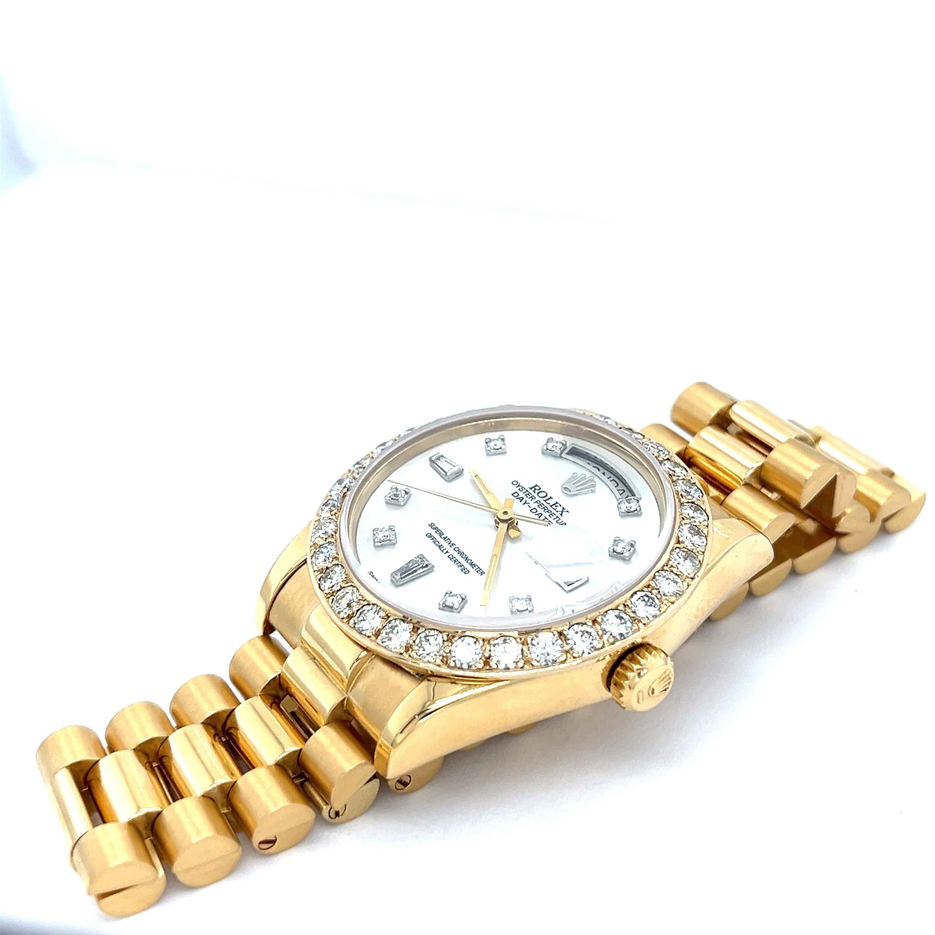Pre-owned 36mm Rolex Datejust President in 18K yellow gold. Embellished with 8 round diamonds and 2 tapered baguette dial markers and a captivating mother of pearl dial, this Datejust President watch is a keepsake to last generations. Complete with