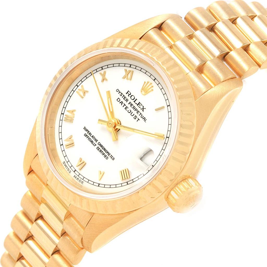 Rolex President Datejust Yellow Gold White Roman Dial Ladies Watch 69178. Officially certified chronometer automatic self-winding movement. 18k yellow gold oyster case 26.0 mm in diameter. Rolex logo on a crown. 18k yellow gold fluted bezel. Scratch