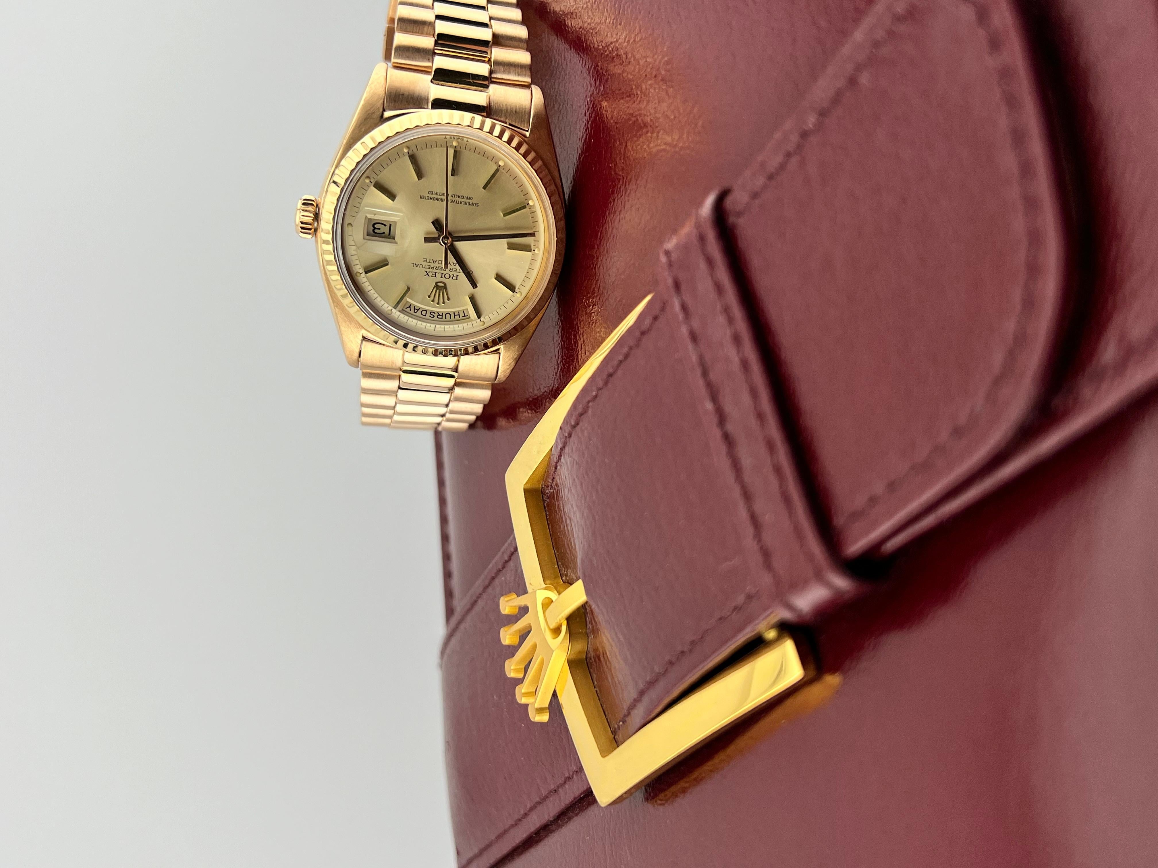 Style Number: 1803
Serial: 215***
Year: 1969
Model: Rolex President Day Date 
Case Material: 18K Rose Gold
Band: 18K Rose Gold 
Bezel: 18K Rose Gold 
Dial: Champagne 
Face: Acrylic
Case Size: 36mm 
Includes: 
-Rolex Box 
-Certified Appraisal 
-1