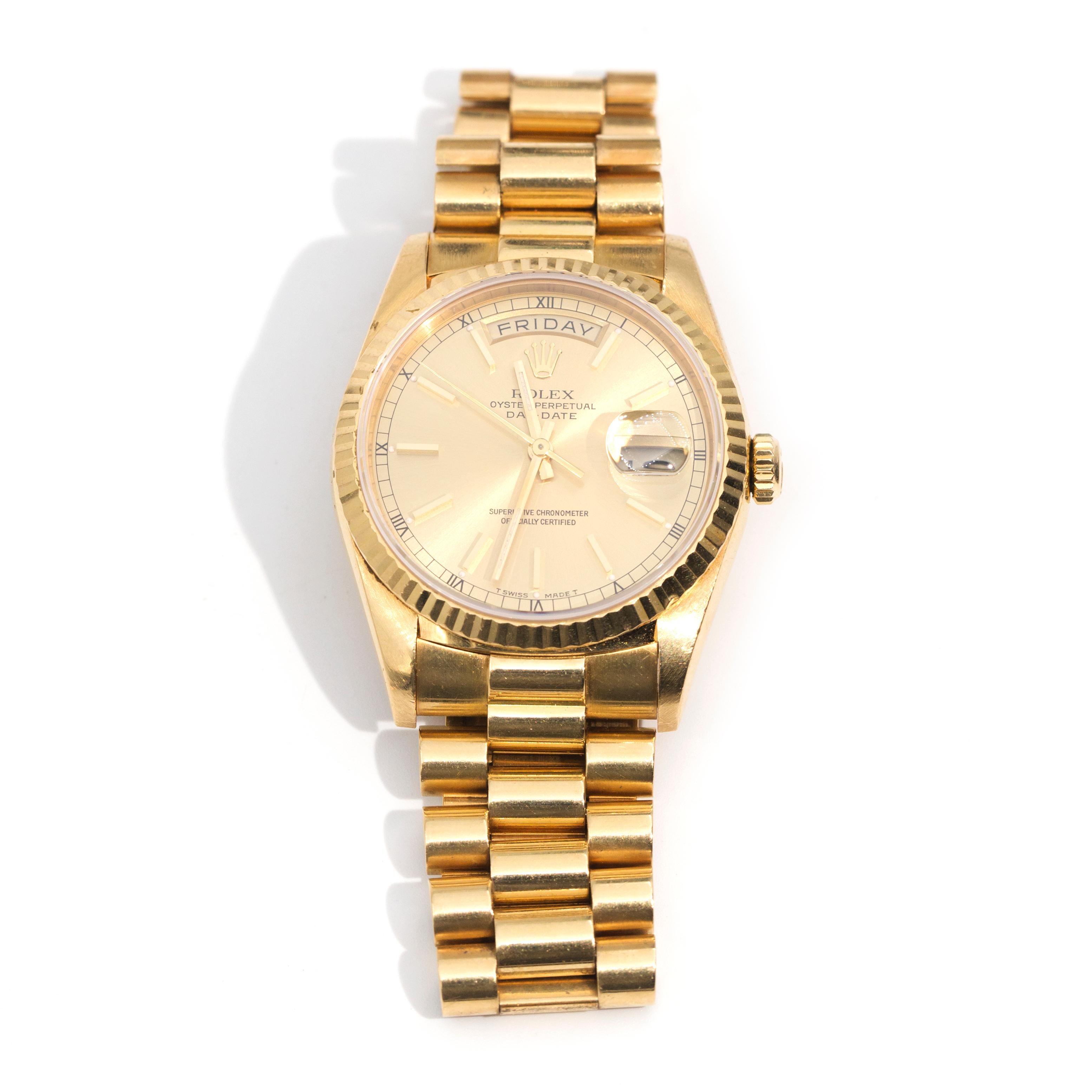 18 carat solid gold Rolex Day-Date President, automatic movement/caliber 3155, 31 jewels, model 18238, 36 millimetre case, champagne dial, gold hands, gold baton hour markers with a luminescent dot to the inner end with black printed Roman numeral